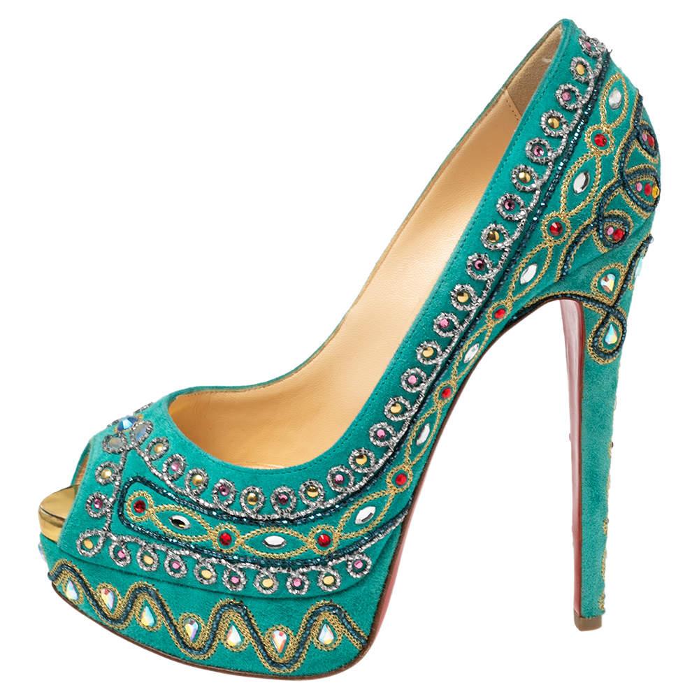 Coming from the House of Christian Louboutin, these impeccable pumps are truly a sight to behold! They are beautifully made from turquoise suede, which is enriched by intricate crystal embellishments throughout. They showcase peep-toes, platforms,