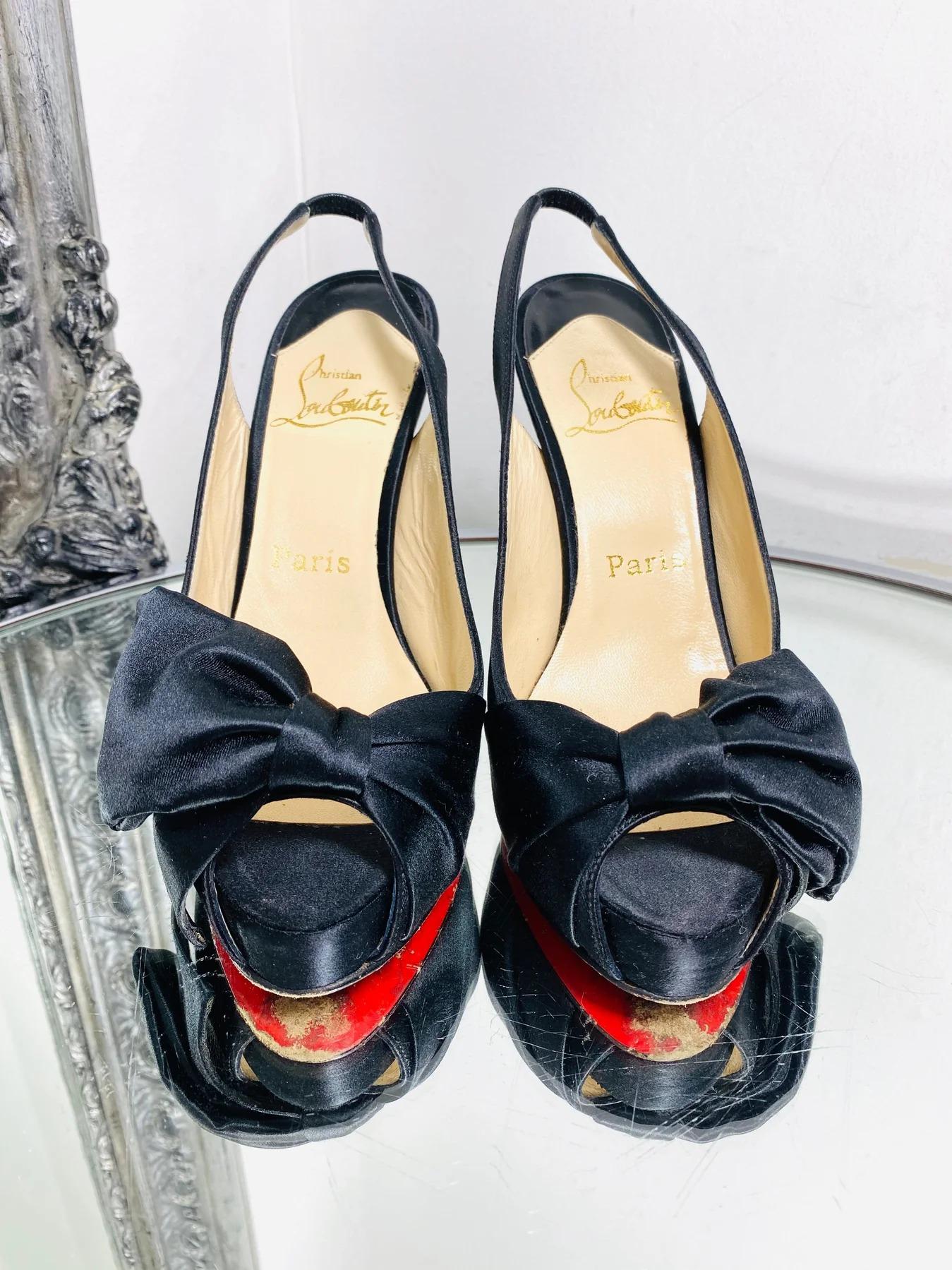 Christian Louboutin Vendome 100 Satin Pumps

Featuring sling-back, platform and peep toe. Designed with oversized bow and 12cm stiletto heel. Iconic 'Louboutin' red soles

Additional information:
Size – 37
Composition – Satin
Condition – Good (Signs