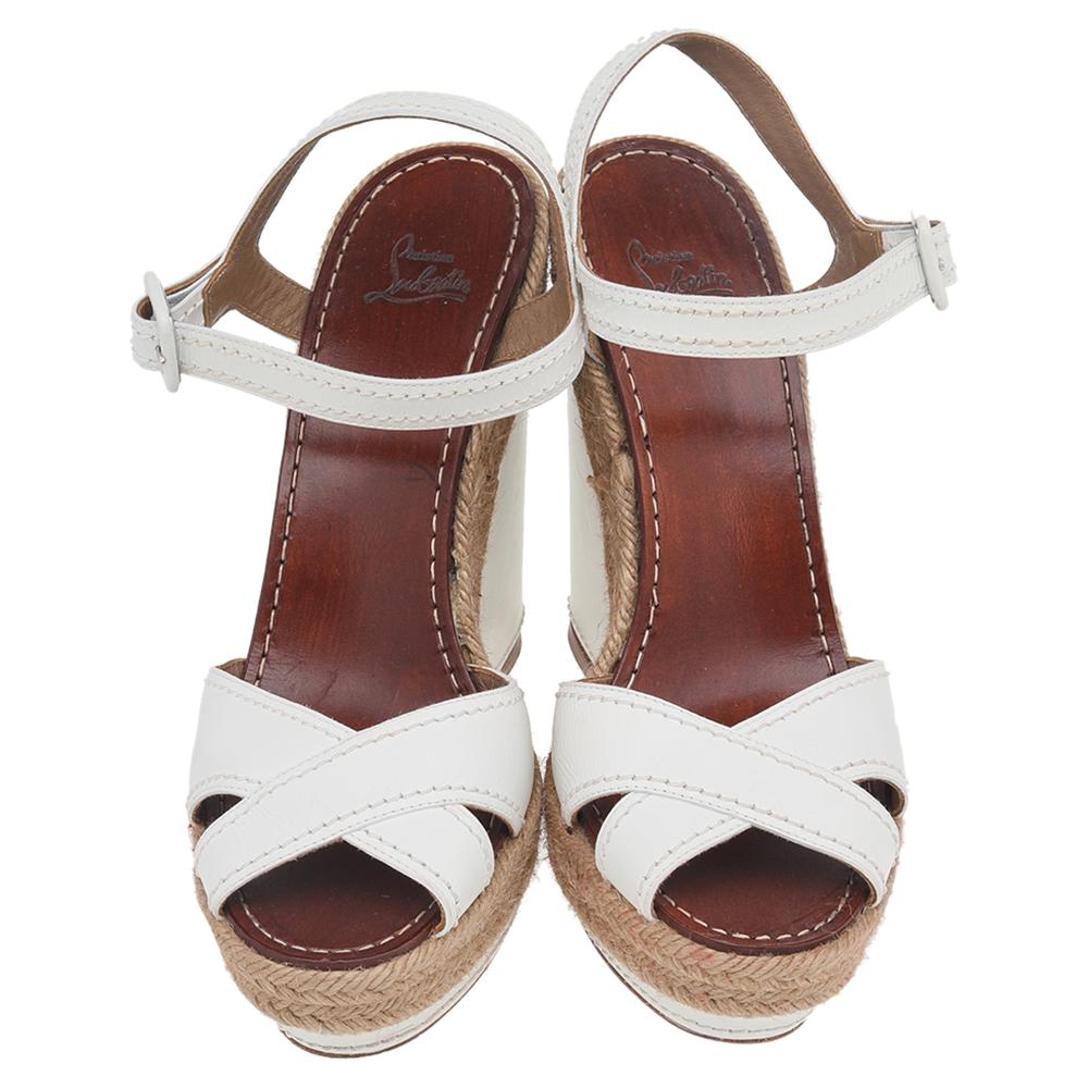 These Almeria sandals from the House of Christian Louboutin will adorn your feet with their elegant silhouette. They are designed using white leather with a cross strap detailing on the upper. To add elevation, they are crafted with 13.5 cm