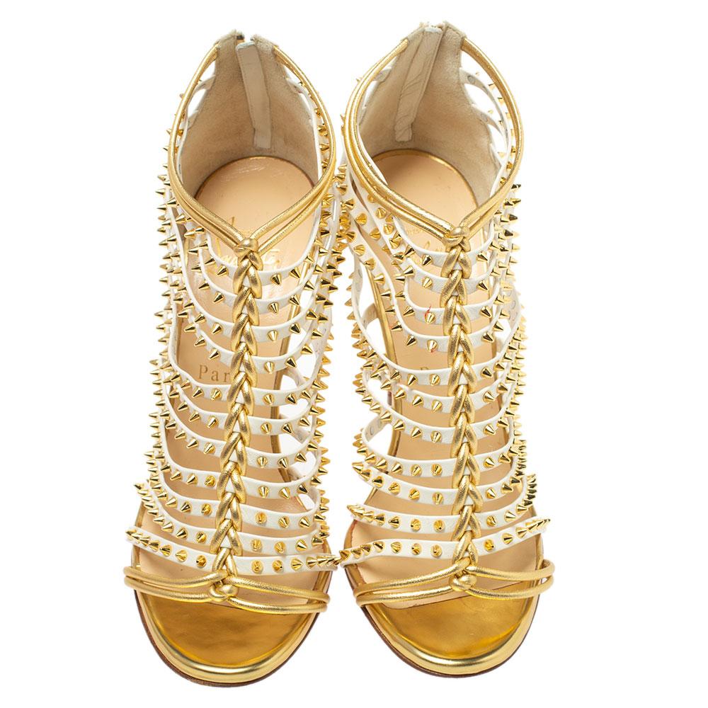 Who doesn't love Louboutins and when it comes to such striking pairs, you are sure to make them yours! These white and gold Millaclou sandals are crafted from leather and feature an open toe silhouette. They flaunt an interesting interplay of