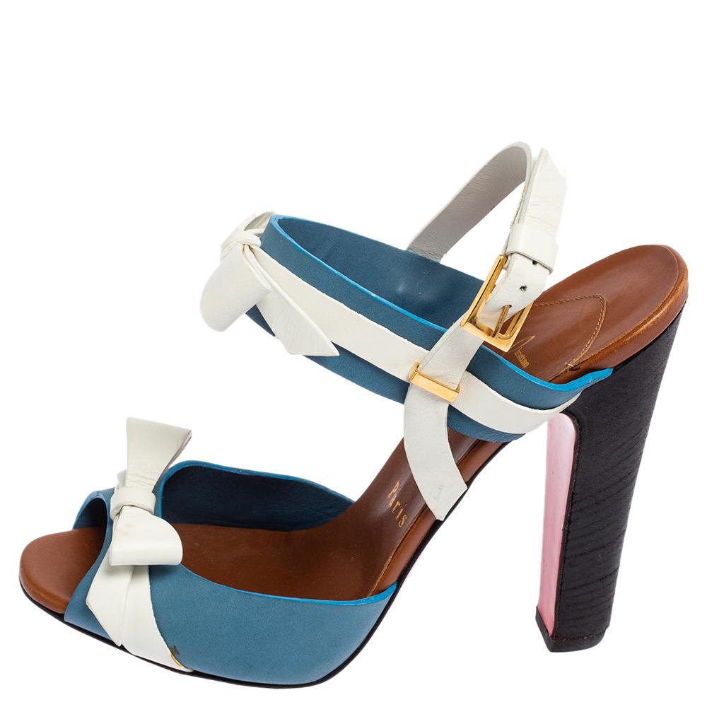 Get a statement look when you slide on these sandals by Christian Louboutin. These 'Lafalaise' sandals are crafted from white & blue leather and feature criss-cross straps across the toes. They are designed with ankle straps with an adjustable