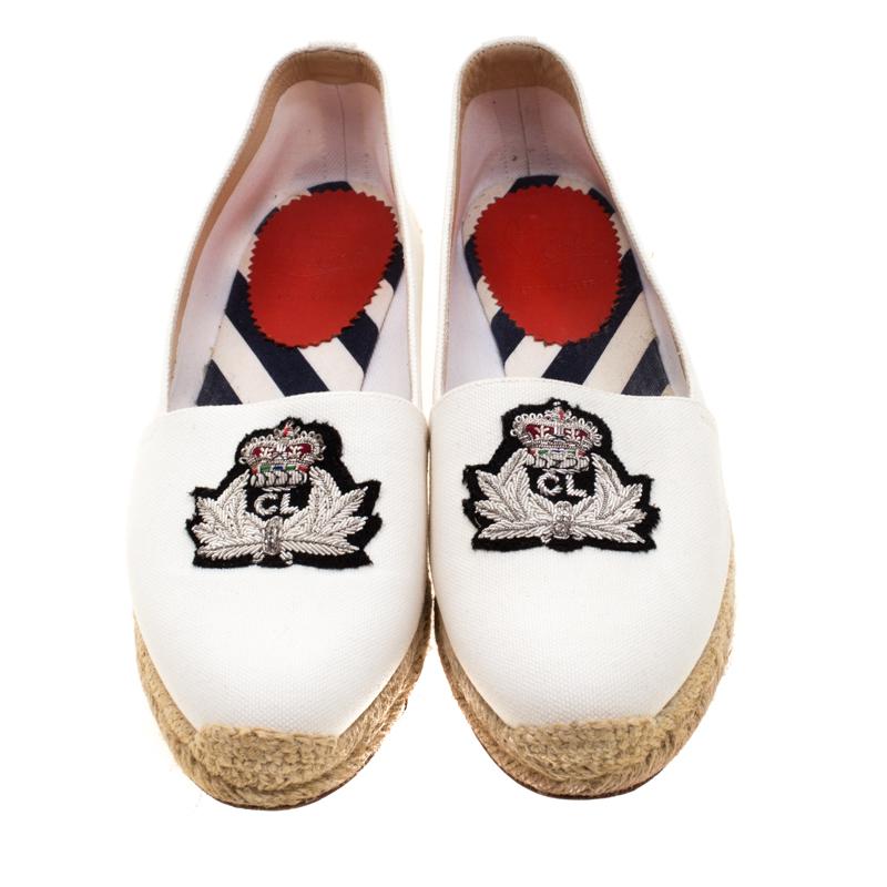 Christian Louboutin brings you these super-stylish espadrille loafers that have been crafted from canvas and designed in a white hue with crests embroidered on the uppers. Braided midsoles and knitted detailing complete this must-have