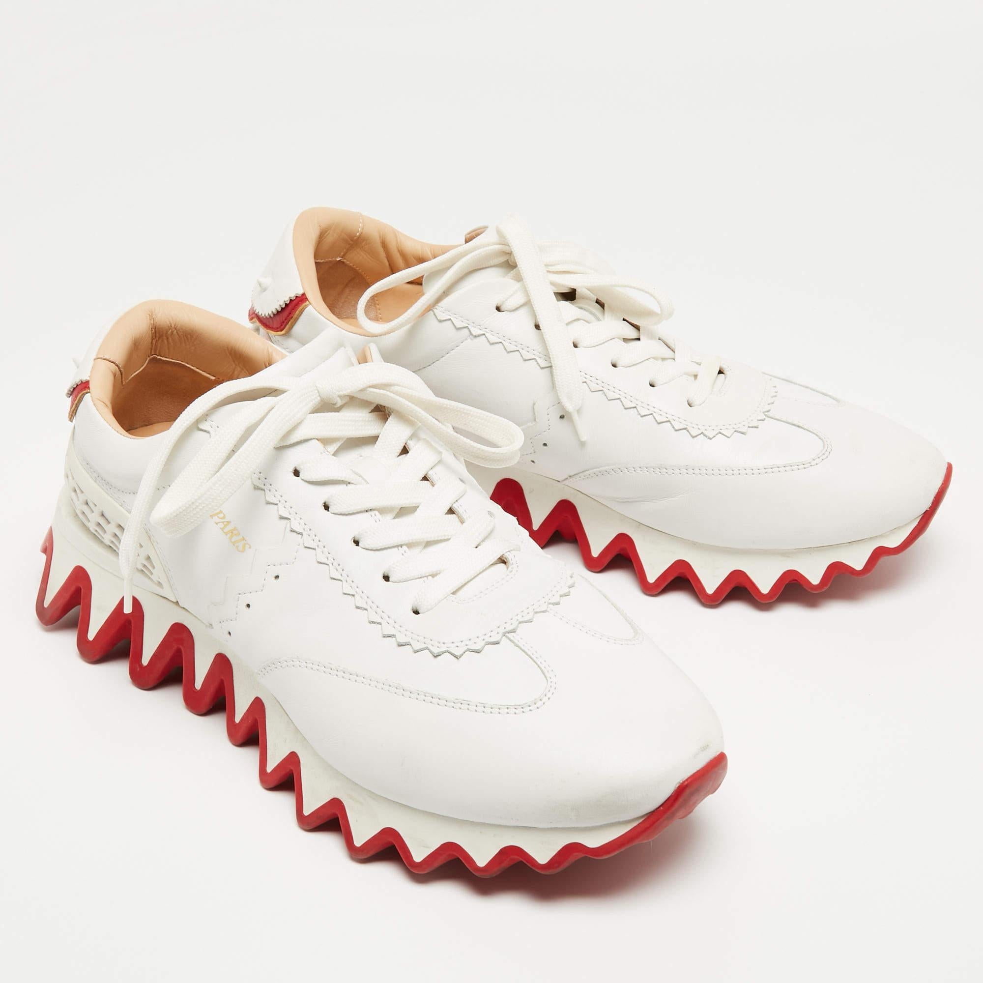 Step up your sneaker game with the Christian Louboutin Loubishark sneakers. Crafted with premium leather, these eye-catching kicks feature a vibrant design that adds a playful touch to any outfit. Complete with the signature red sole and lace-up