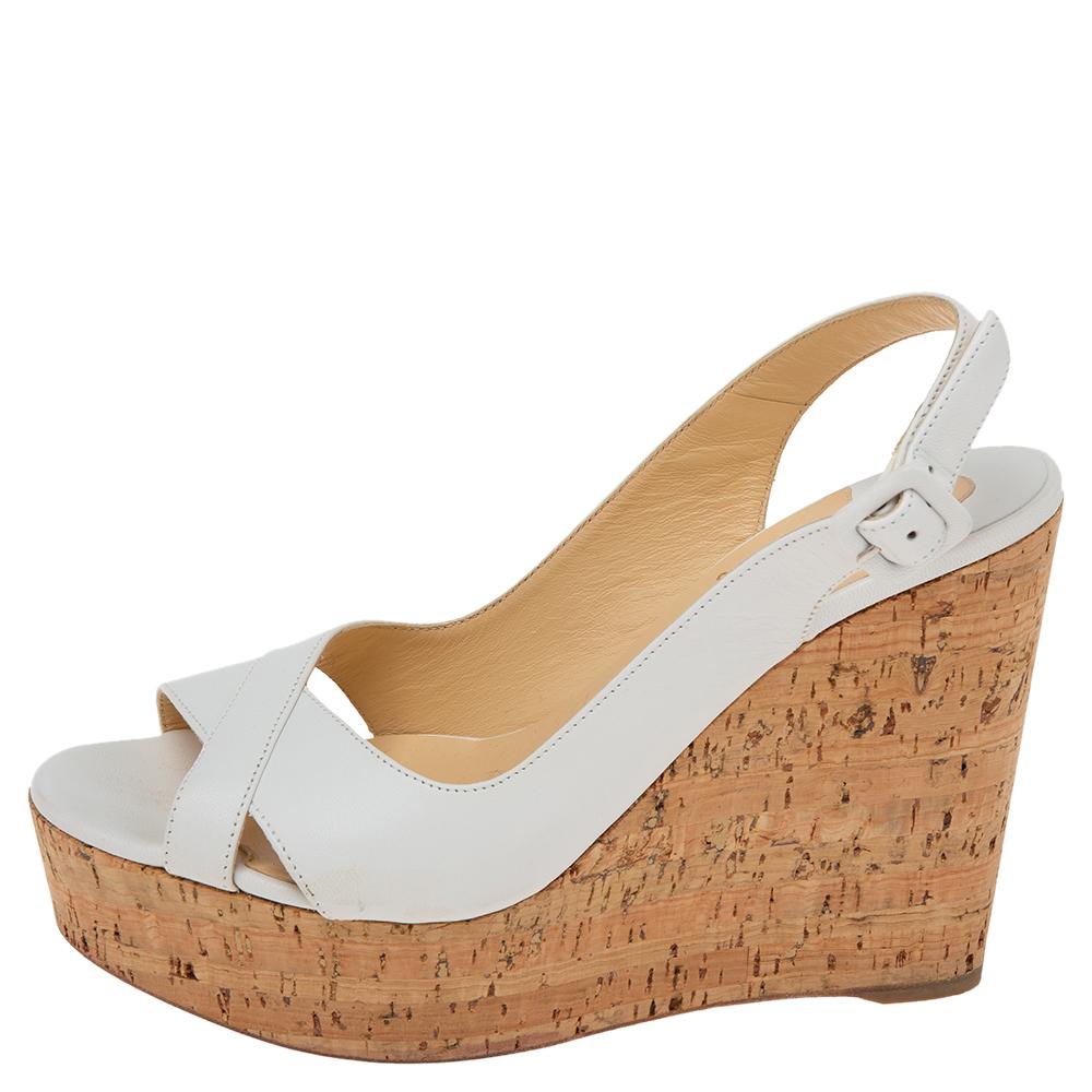 Upgrade any casual look by adding these Christian Louboutin wedge sandals. They are crafted from white leather and designed with open toes, buckled slingbacks, and 11.5 cm cork wedge heels.

Includes: Original Dustbag