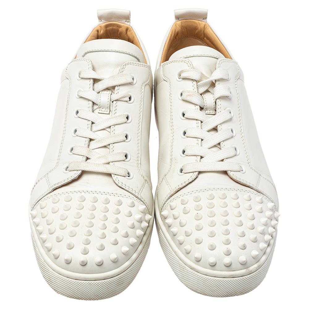 A stunning update on a signature design, these Christian Louboutin sneakers are a must-have. The pair has round toes, lace-up vamps, and spikes that are hand-placed on the cap toes for an edgy finish. The sneakers have a smooth finish and
