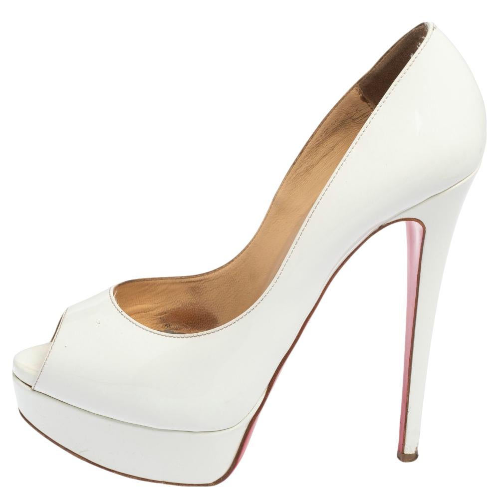 Stand out from a crowd with this gorgeous pair of Louboutins that exude high fashion with class! Crafted from patent leather, this is a creation from their Lady Peep collection. They feature a classic white shade with peep toes and a glossy