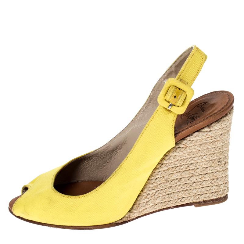 This pair from Christian Louboutin definitely deserves your love as it is well-built and exquisite in appeal. They've been crafted from bright yellow canvas and styled with buckled slingback straps, peep toes and 9 cm espadrille wedges. Accessorise