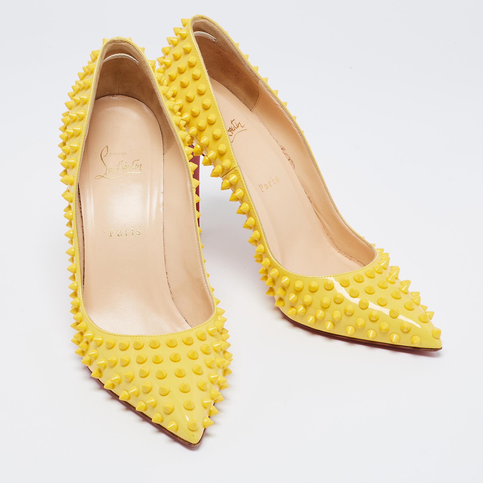 Dazzle everyone with these Louboutins by owning them today. Crafted from patent leather, these summery, bright yellow pumps carry a sleek shape with studded spikes all over, pointed toes, and 11 cm heels. Complete with the signature red soles, this