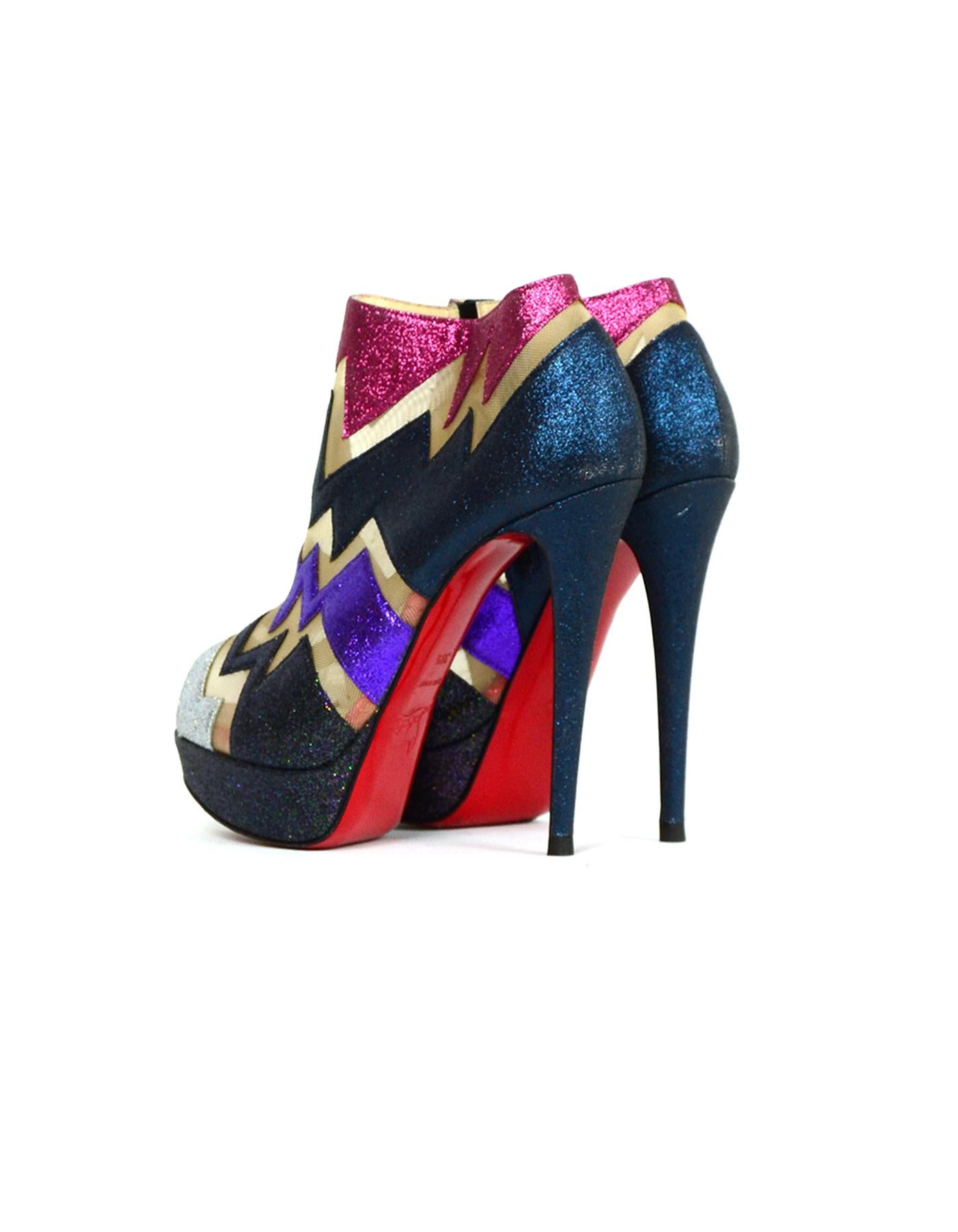 Christian Louboutin ZIGGY 150 Multi-color Glitter Platform Booties sz 38.5

Made In: Italy
Color: Red, purple, navy
Hardware: Black
Materials: Mesh, glitter
Closure/Opening: Side zip
Overall Condition: Good pre-owned condition Minor stains on