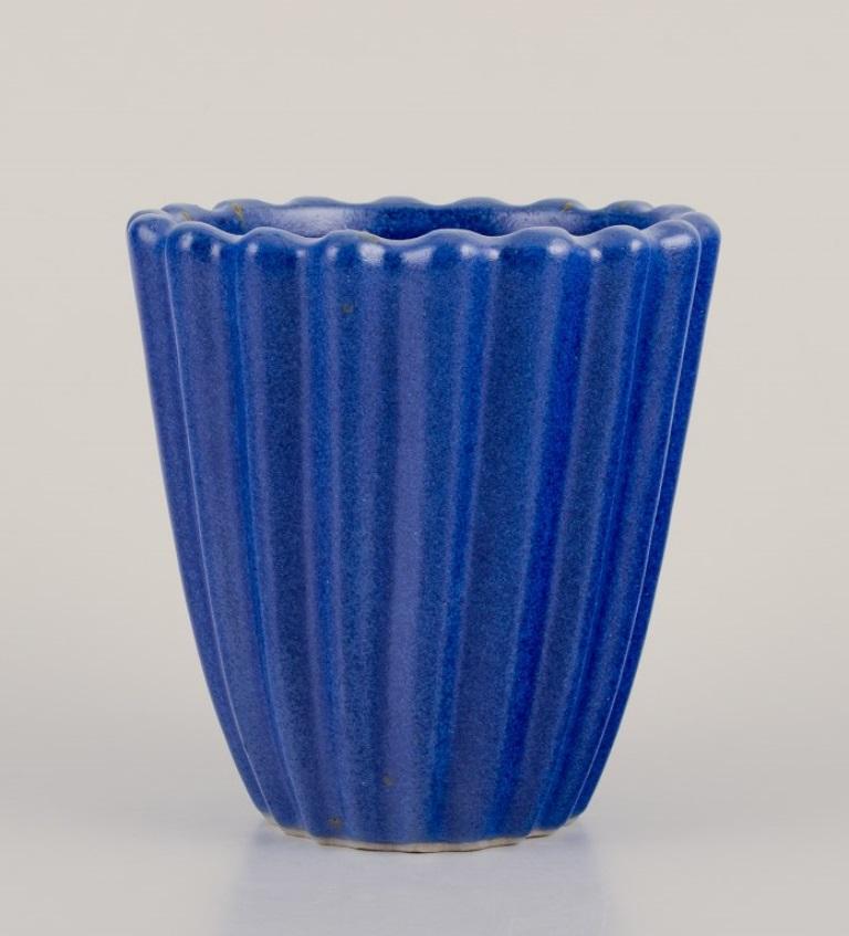 Christian Poulsen, own workshop, Denmark. 
Unique ceramic vase in grooved design.
Blue glaze.
Signed and dated 1937.
Perfect condition. 
Dimensions: Height 10.5 cm. x diameter 10.0 cm.
Provenance: Private Danish ceramics collection

