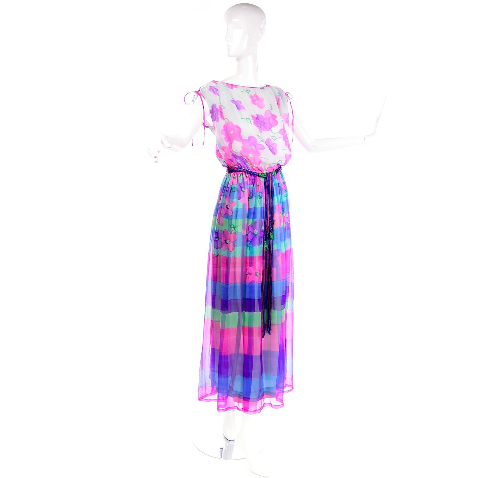 This is a fabulous vintage 1970's Christian Rupert maxi Dress with a floral chiffon bodice and a striped & floral patterned skirt.  The dress has a wonderful multi colored knotted string belt and ties at the shoulders.  The skirt itself has a lining