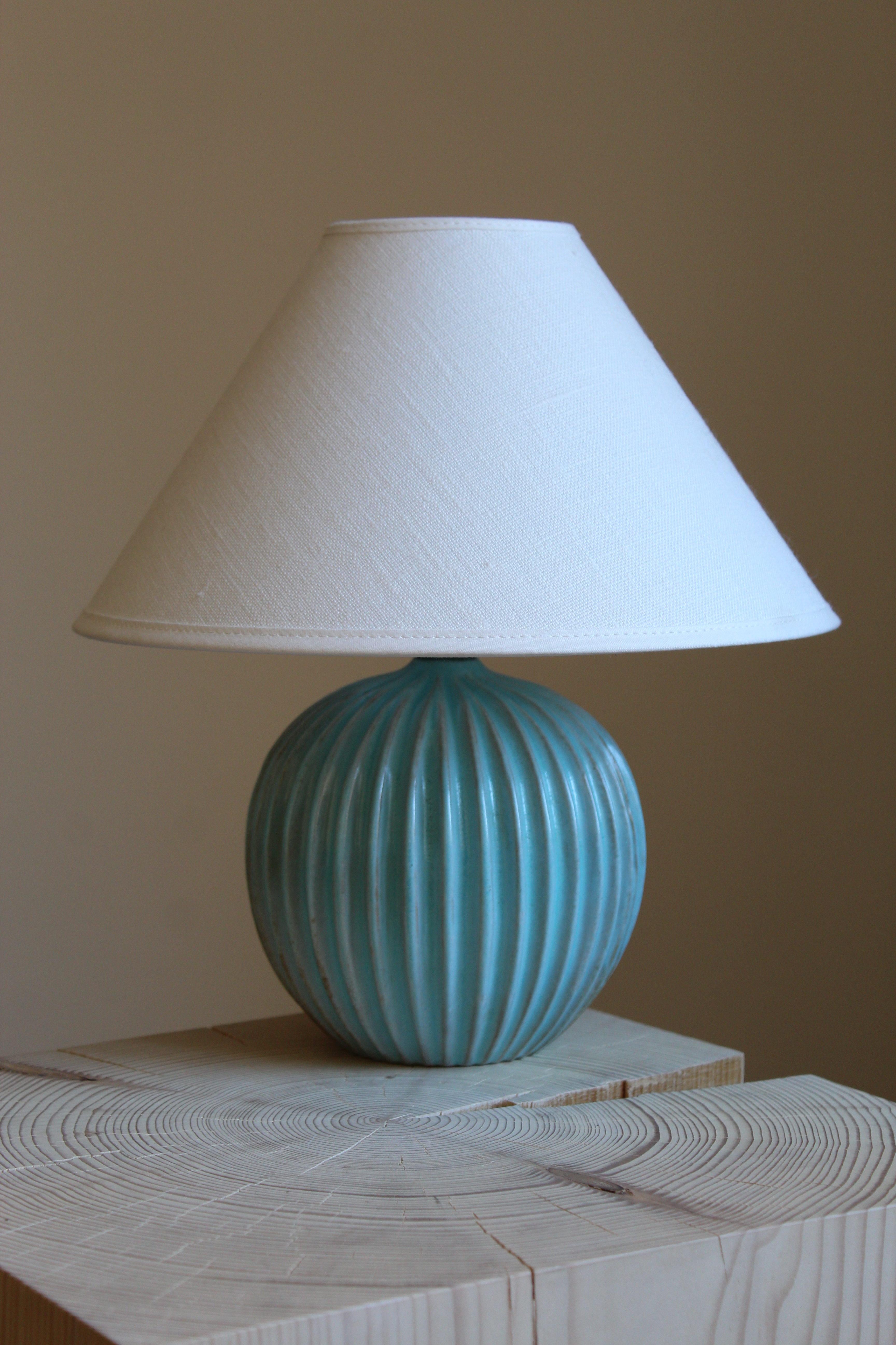 A table lamp produced by Christian Schollert. In blue-glazed stoneware. Produced in Denmark, 1960s. Signed. Sold without lampshade.