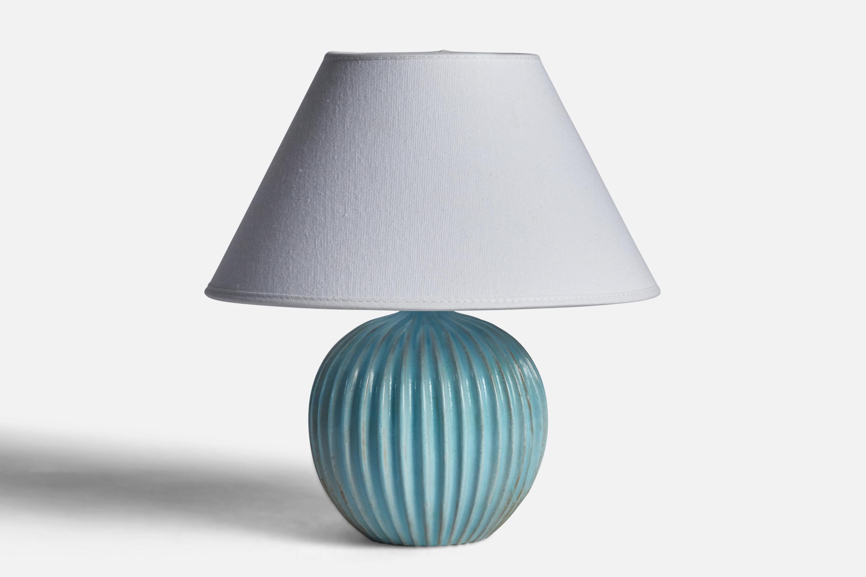 A light blue-glazed stoneware table lamp designed and produced by Christian Schollert, Denmark, c. 1960s.

Dimensions of Lamp (inches): 7.65” H x 5.5” Diameter
Dimensions of Shade (inches): 4.5” Top Diameter x 10” Bottom Diameter x