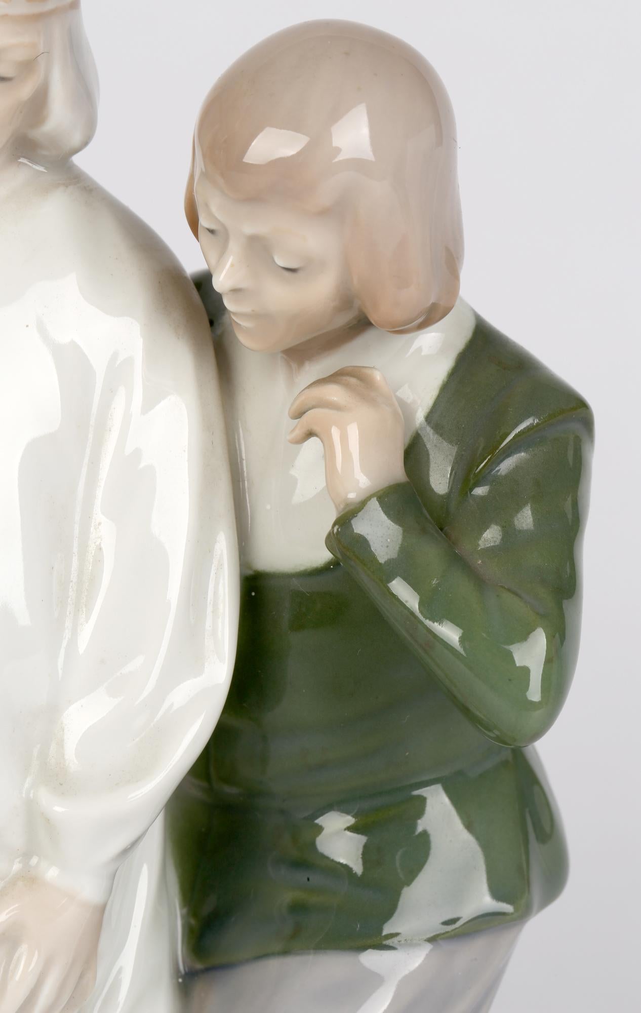A scarce Danish Royal Copenhagen porcelain figure titled The Emperors New Clothes designed by Christian Thomsen (1860-1921) and dating between 1975-1979. The figure stands raised on a rectangular base and portrays the emperor standing wearing a