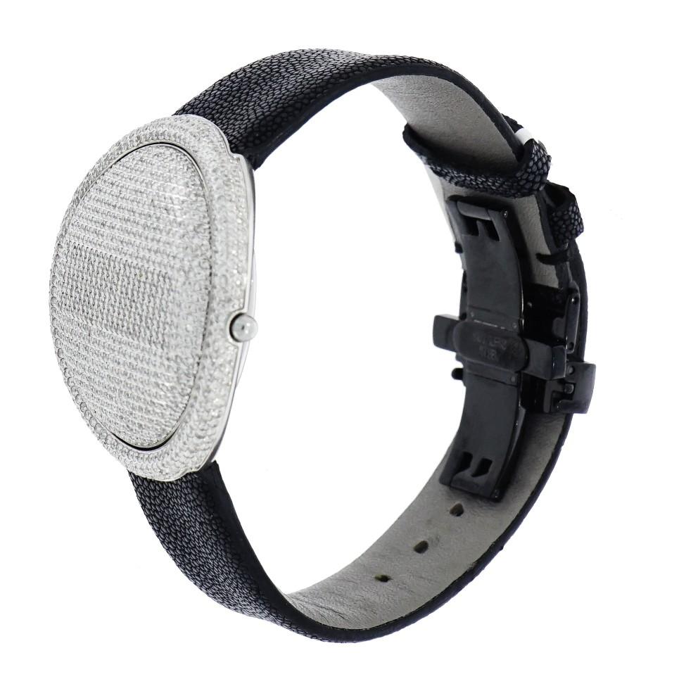 Pre-owned in  good condition Christian Tse Prismatic  Limited Edition digital watch, 42mm stainless steel case set with 950 diamonds, total carat weigh of 4.75, GH color Vs  clarity, on  a black stingray strap with folding buckle. This watch is