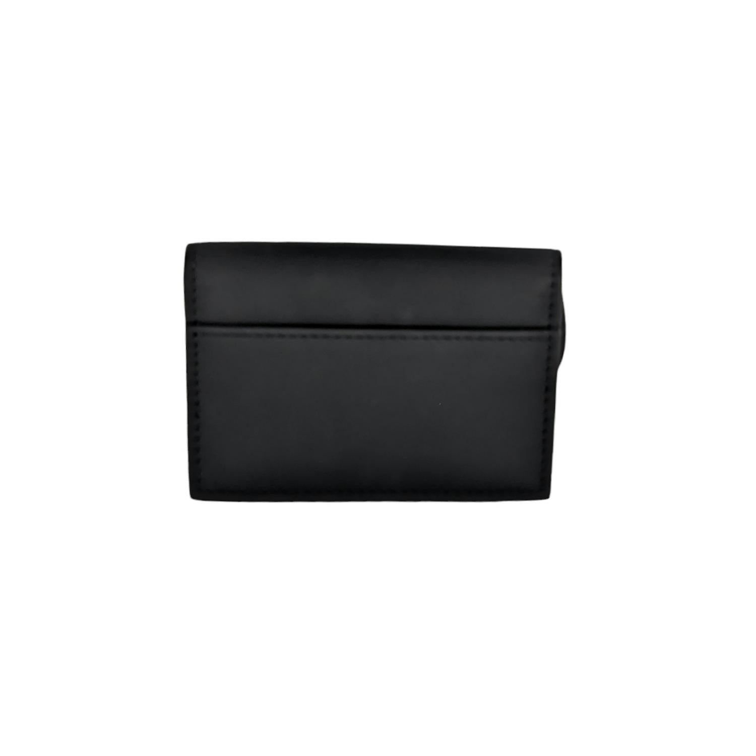 The Saddle flap card holder is a compact and practical alternative to the traditional wallet. Crafted in black ultra matte calfskin, the artisanal design is durable and can hold the daily essentials. The small and easy-to-use companion may be paired