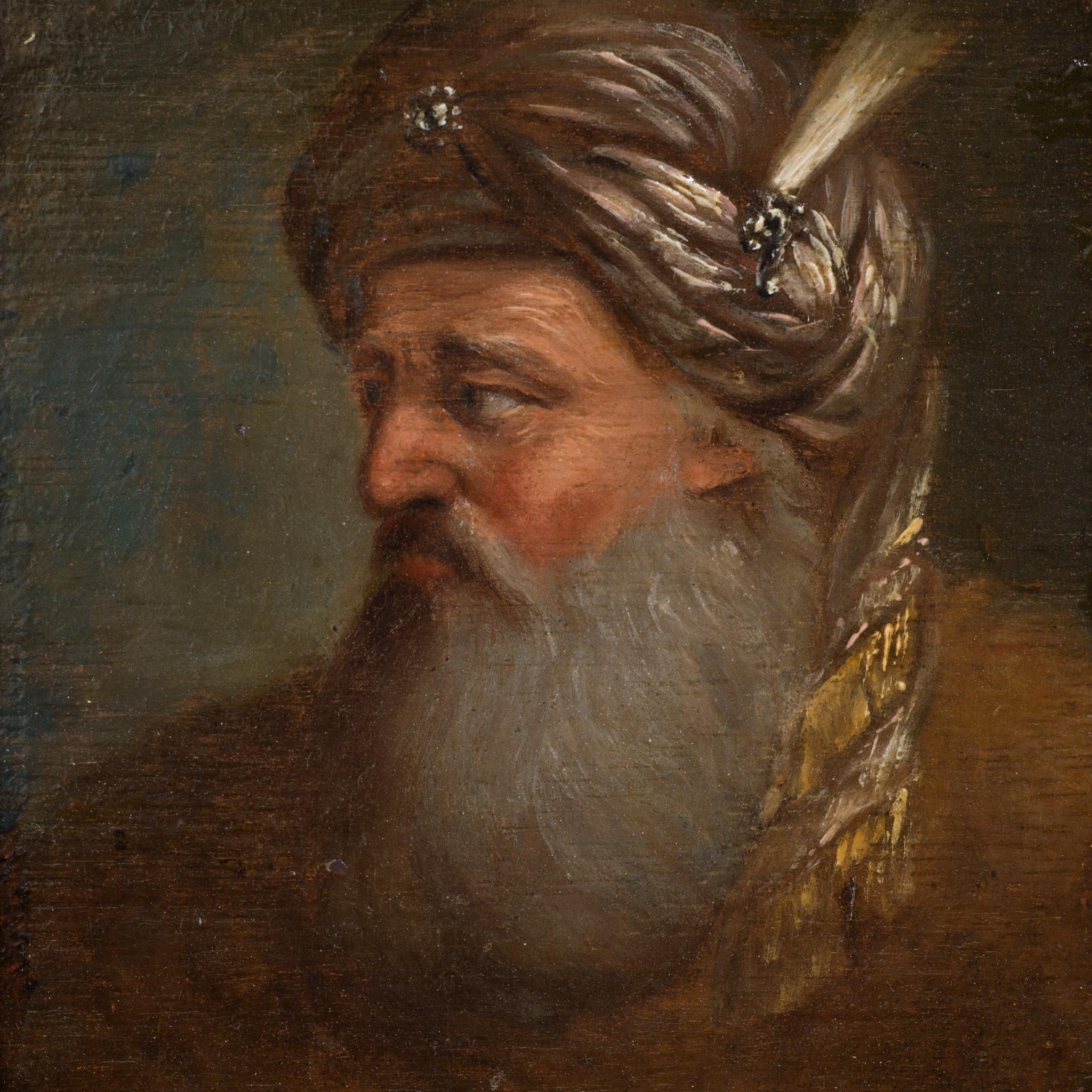 This finely executed oil painting, attributed to the circle of Christian Wilhelm Ernst Dietrich, depicts a bearded man wearing an ornate turban adorned with jewels and a feather. The subject’s profile is skillfully rendered with subtle variations in