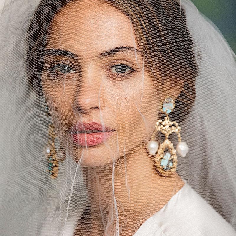 The Liliana Earrings are handcrafted in Europe. Created with 24k gold-plated brass, the Liliana Earrings feature natural hand-cut Turquoise with freshwater pearls. Perfect for special occasions, garden weddings, bridal and cocktail parties. 

Please