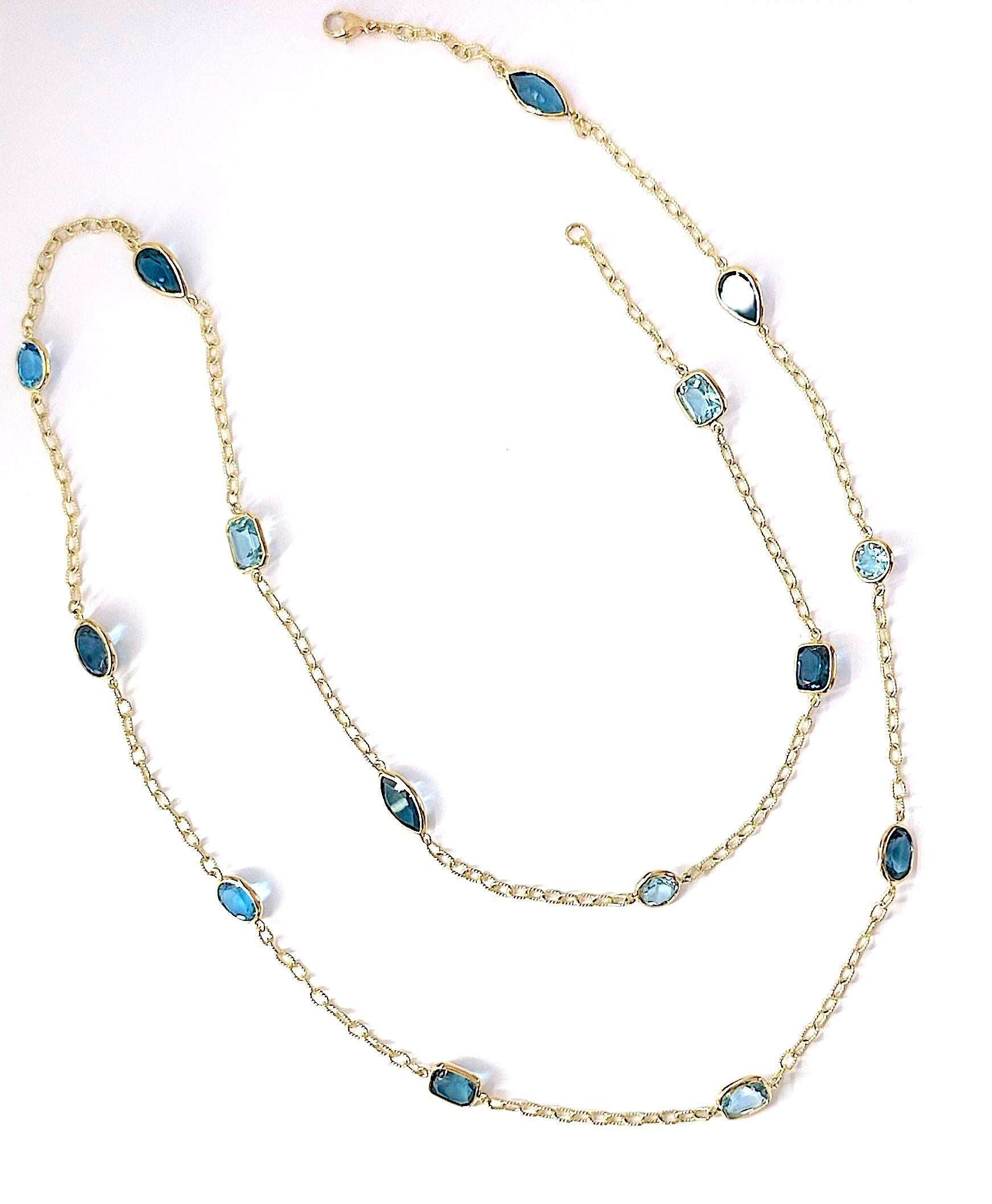 18kt Bespoke Multi Shaped Blue Topaz stones of varying shades set along an elegant twisted link chain.

 The stones are set approximately two inches apart.

The necklaces measures 36