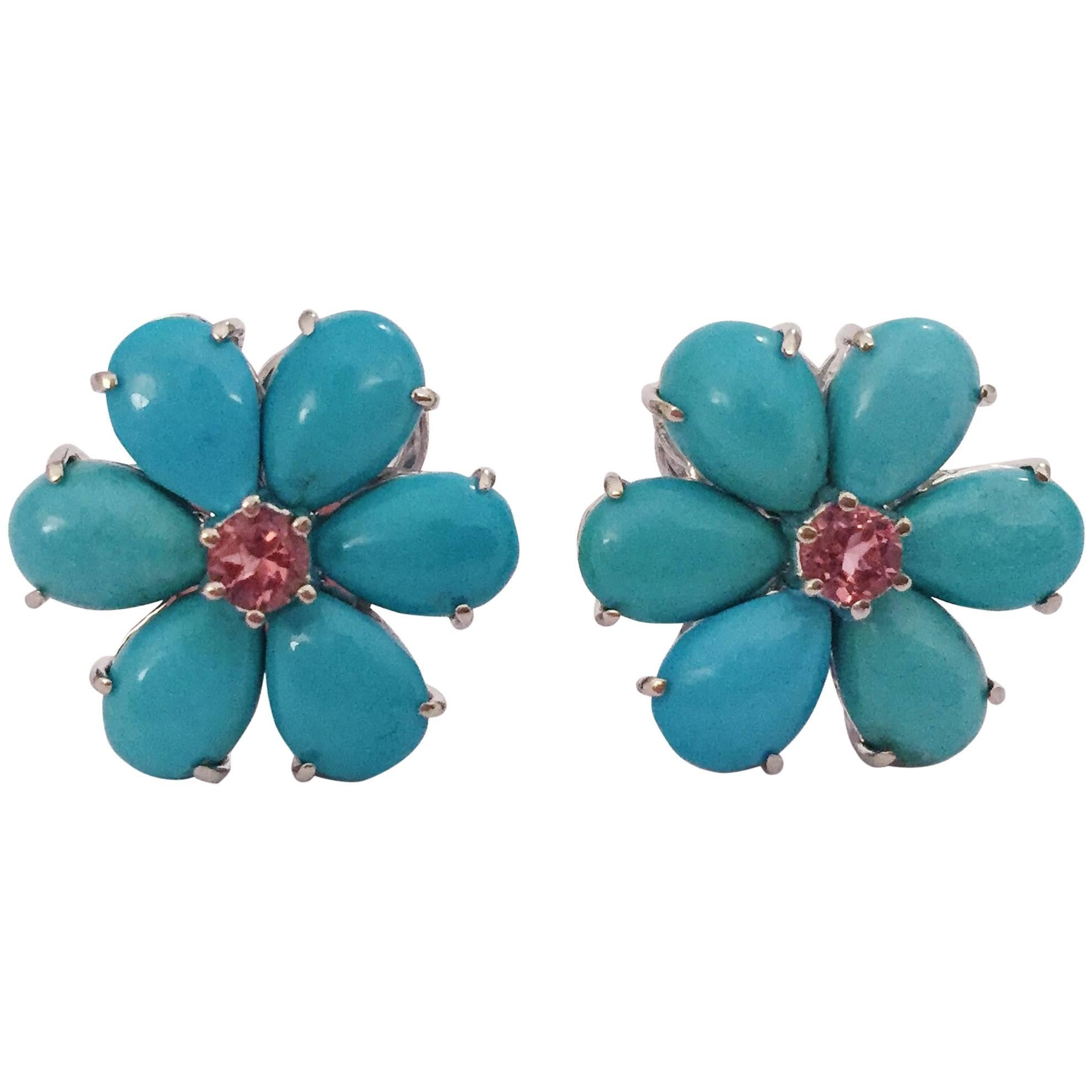 Christina Addison 18kt White Gold Turquoise Flower Earring with 12 Pear shaped print set Turquoise surrounding a print set Faceted Rubellite Center.

The earrings measure 3/4