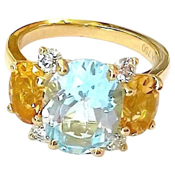 Christina Addison Bespoke 18kt Yellow Gold Small GUM DROP™ Ring with BlueTopaz (approx 3.5cts) and two Iolite (approx 5 cts total) and Diamonds approximately~ 0.25cts

This beautiful ring measures ~ 1  