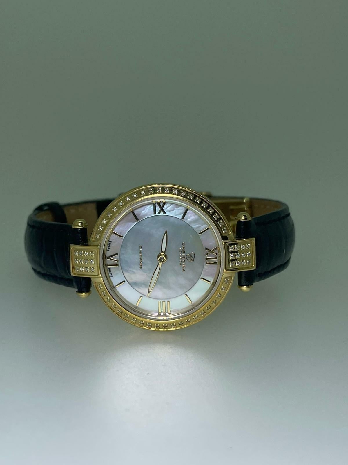 Fabulously designed by Christina Hembo - a renowned Danish jewellery & watch designer 
from CHRISTINA Design London, 

this wristwatch is centering an 18K gold plated 27mm circular case,
with bezel & lugs adorned with round brilliant cut diamonds