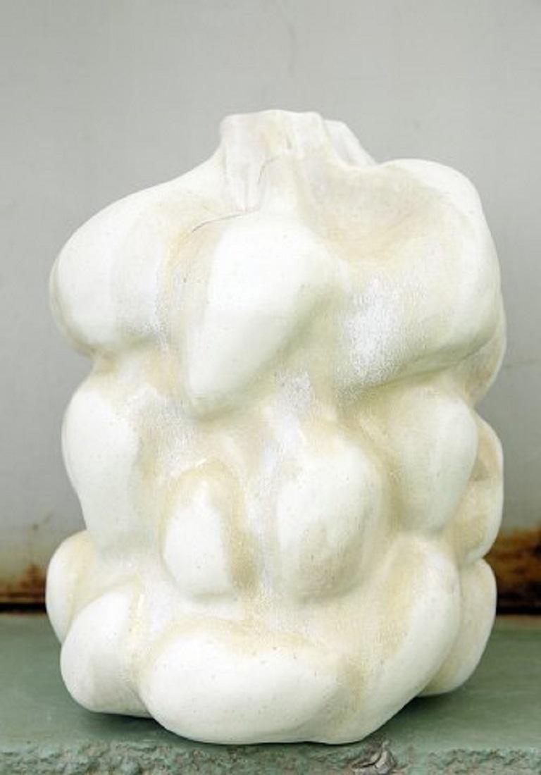 Christina Muff, Danish contemporary ceramicist (b. 1971). 
Large hand modelled sculptural vase with a bottleneck opening, made in soft white stoneware clay. Creamy white slightly speckled glaze with warm golden glaze runs. Part of the Salt series