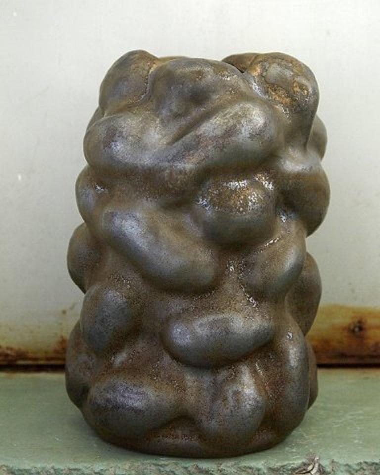 Christina Muff, Danish contemporary ceramicist (b. 1971). 
Large unique sculptural vase in stoneware. The glaze is a golden brown copper color that is really expressed in the areas where it is applied thickly, as they become almost metallic. The