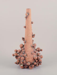 Christina Muff, contemporary Danish artist. Tall vessel covered in clay balls.