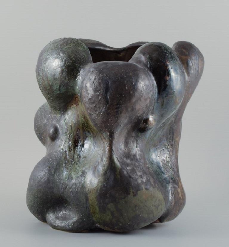 Christina Muff, Danish contemporary ceramicist (b. 1971). 
Monumental work in stoneware clay, covered in blackish-green glaze with the occasional specks of blue on a semi-rough surface.
Measuring: W 34 x H 38 cm.
In excellent