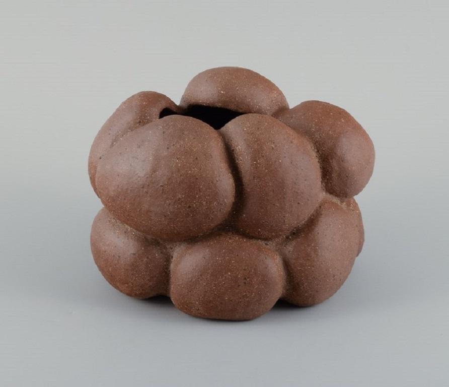 Christina Muff, Danish contemporary ceramicist (b. 1971). 
Golden brown unglazed stoneware clay vessel with specks. Organically shaped. Clear glaze inside. 
Measuring: W 23 x H 17 cm.
In excellent condition.
Signed.

Technique - Christina Muff’s
