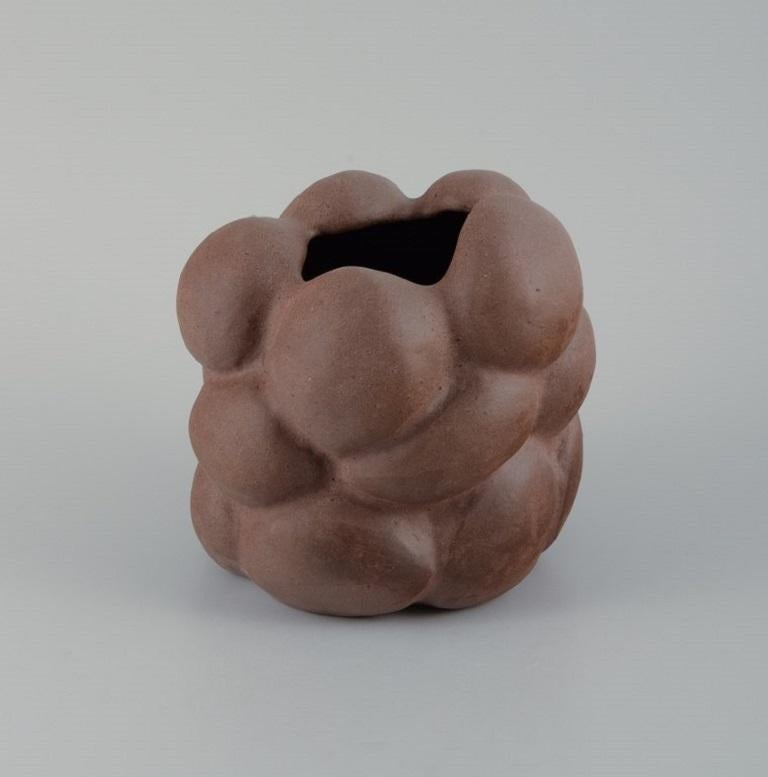 Christina Muff, Danish contemporary ceramicist (b. 1971). 
Reddish brown organically shaped stoneware vase. Clear glaze on the inside.
Measuring: W 15 x H 17 cm.  
In excellent condition.
Signed.

Technique - Christina Muff’s forms are modelled by