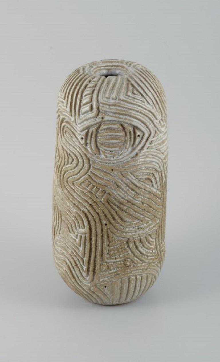 Christina Muff, Danish contemporary ceramicist (b. 1971). 
Unique, hand-carved vase in stoneware clay. Covered in a shiny, semi-transparent glaze with white flakes.
Measuring: D 13 x H 29 cm.
In excellent condition.
Signed.

Technique - Christina