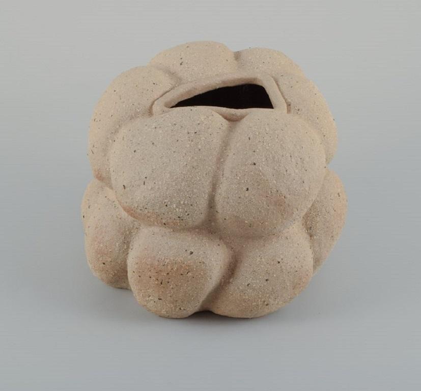 Christina Muff, Danish contemporary ceramicist (b. 1971). 
Unique stoneware vase. Unglazed, with specks, organically shaped.
Measuring: W 18 x H 16 cm.
In excellent condition.
Signed.

Technique - Christina Muff’s forms are modelled by hand