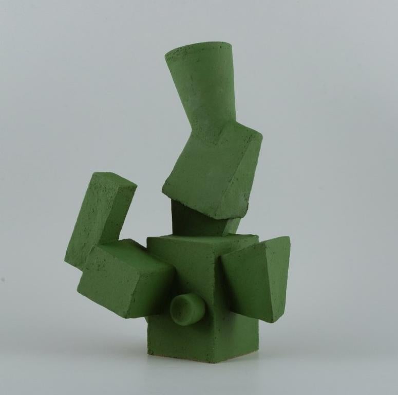 Christina Muff, contemporary Danish ceramicist (b. 1971). 
Unique cubist stoneware sculpture in matte grass green glaze.
In perfect condition.
Signed.
Dimensions: W 22.0 cm. x H 35.0 cm.

Technique - Christina Muff’s forms are modelled by hand using