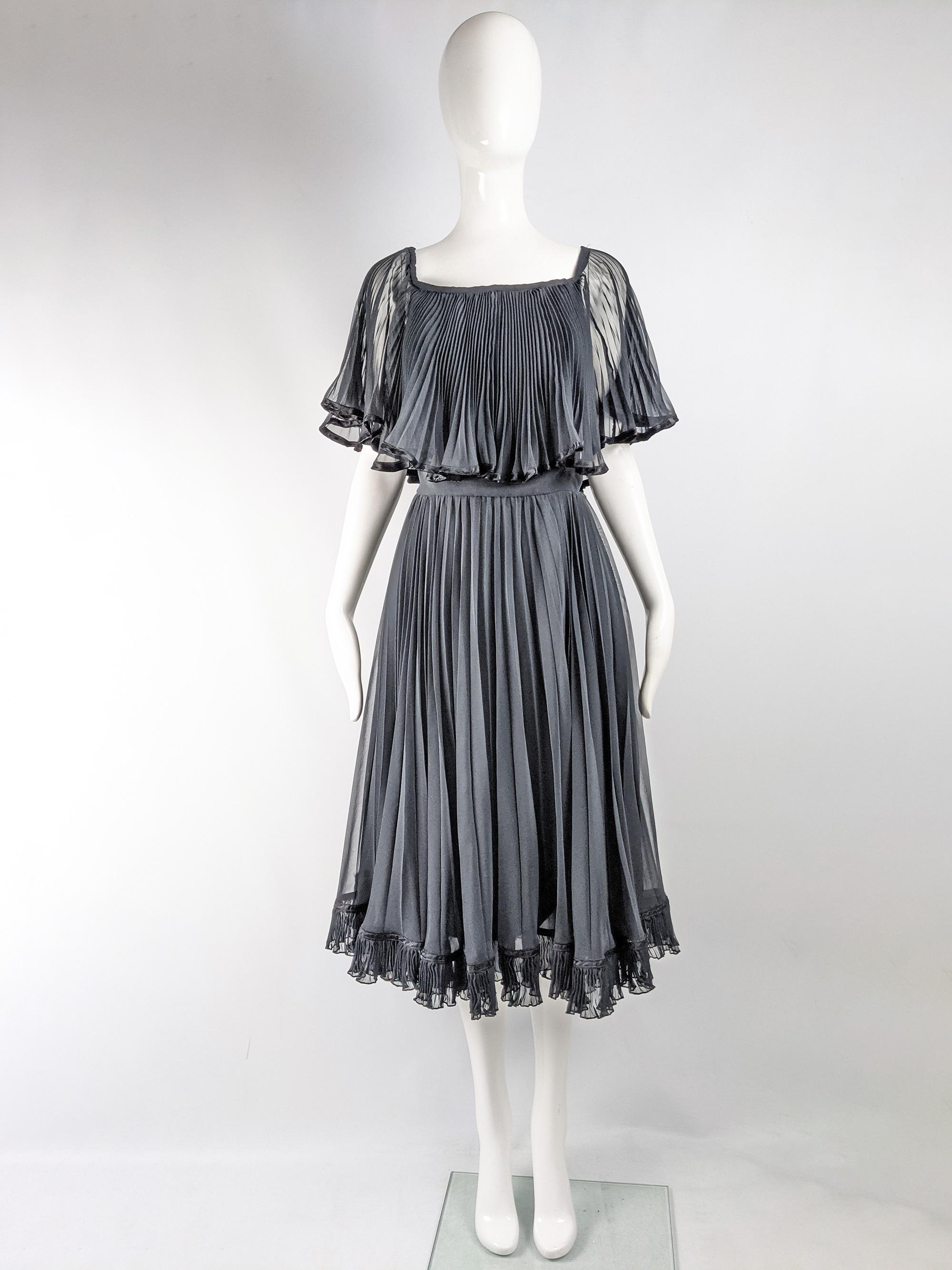 A fabulous vintage womens dress from the 80s by British fashion designer, Christina Stambolian, who often designed for Royals and celebrities, including Princess Diana's iconic 'Revenge Dress'. In a pleated darkest gray / black chiffon with angel