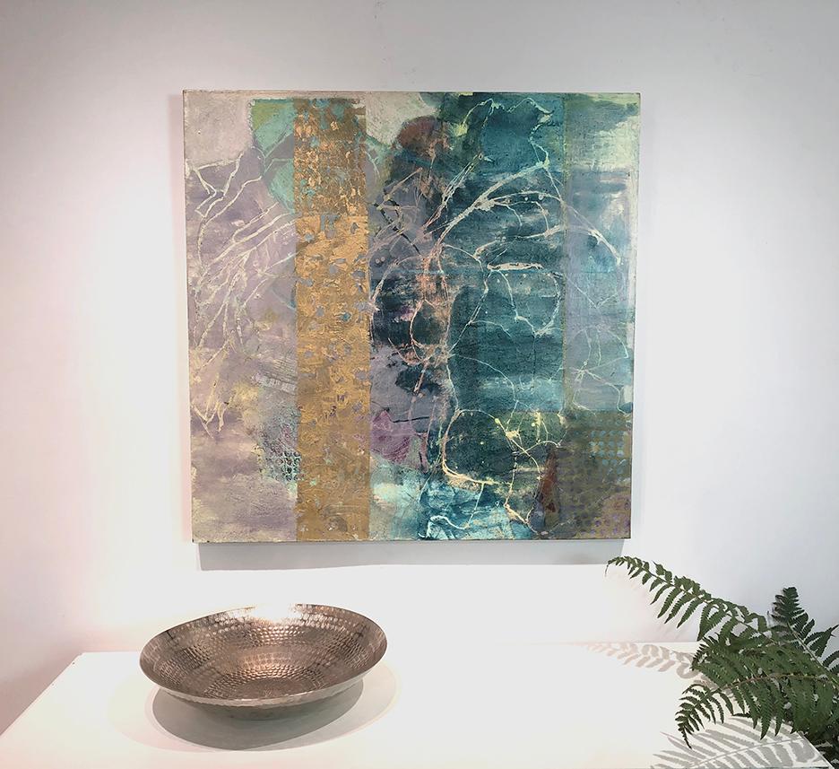 This abstract painting by artist Christine Averill-Green is made with oil and mixed media on canvas. Blue, purple, and teal colors blend together beautifully and are juxtaposed by metallic gold paint embellishments, causing the painting to change in