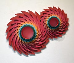 Marte chupa un relieve geométrico circular para pared con rojos, azules y verdes
