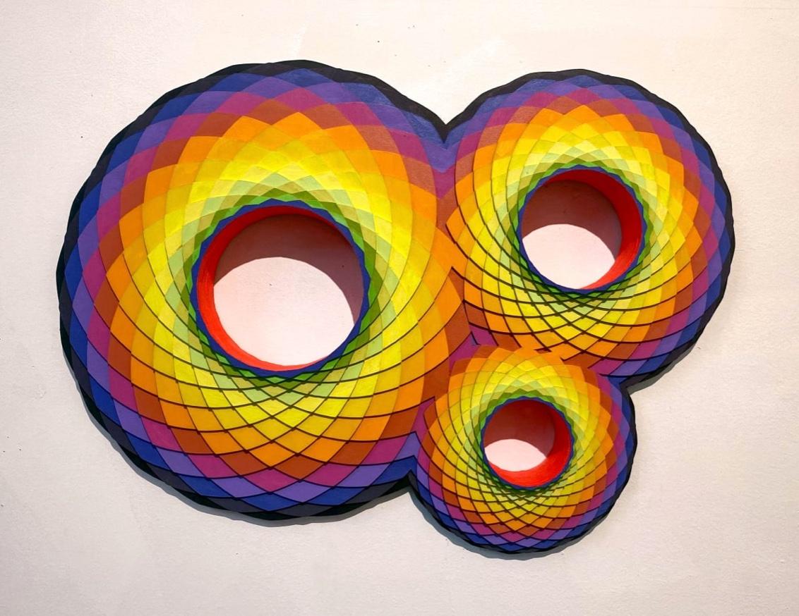 TriVortex, multi-color circular wood wall sculpture by Christine Romanell