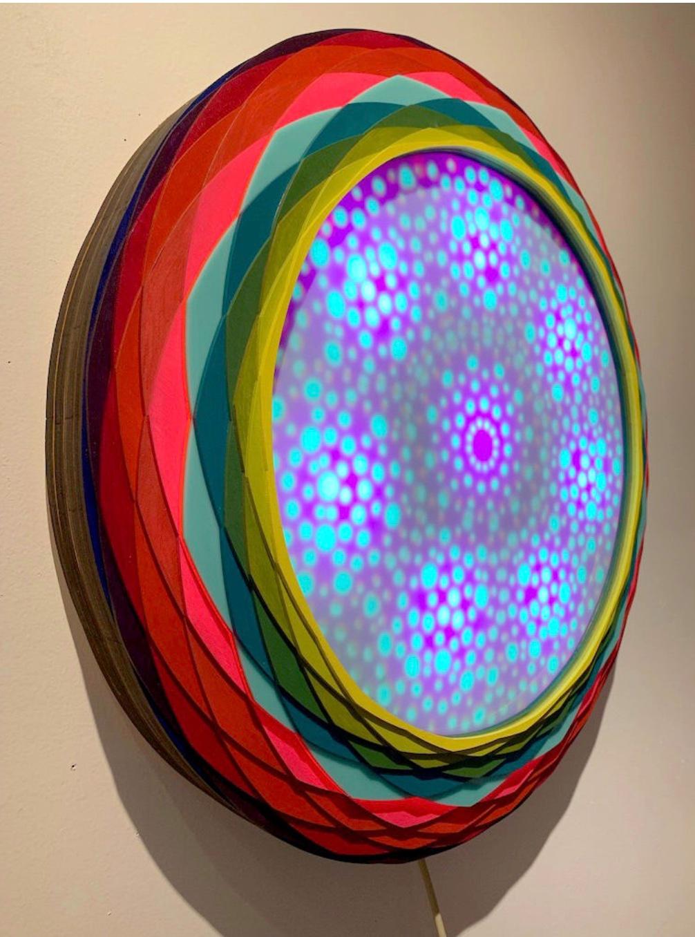 Acrylic on Lasercut wood, LEDs, Ardino, motion censor 30 x 30 x 4 in (76.2 x 76.2 x 10.16 cm)

Christine Romanell was born in Paterson, NJ. Her work focuses on aperiodic patterns as they relate to the underlying structures of reality. She sets up