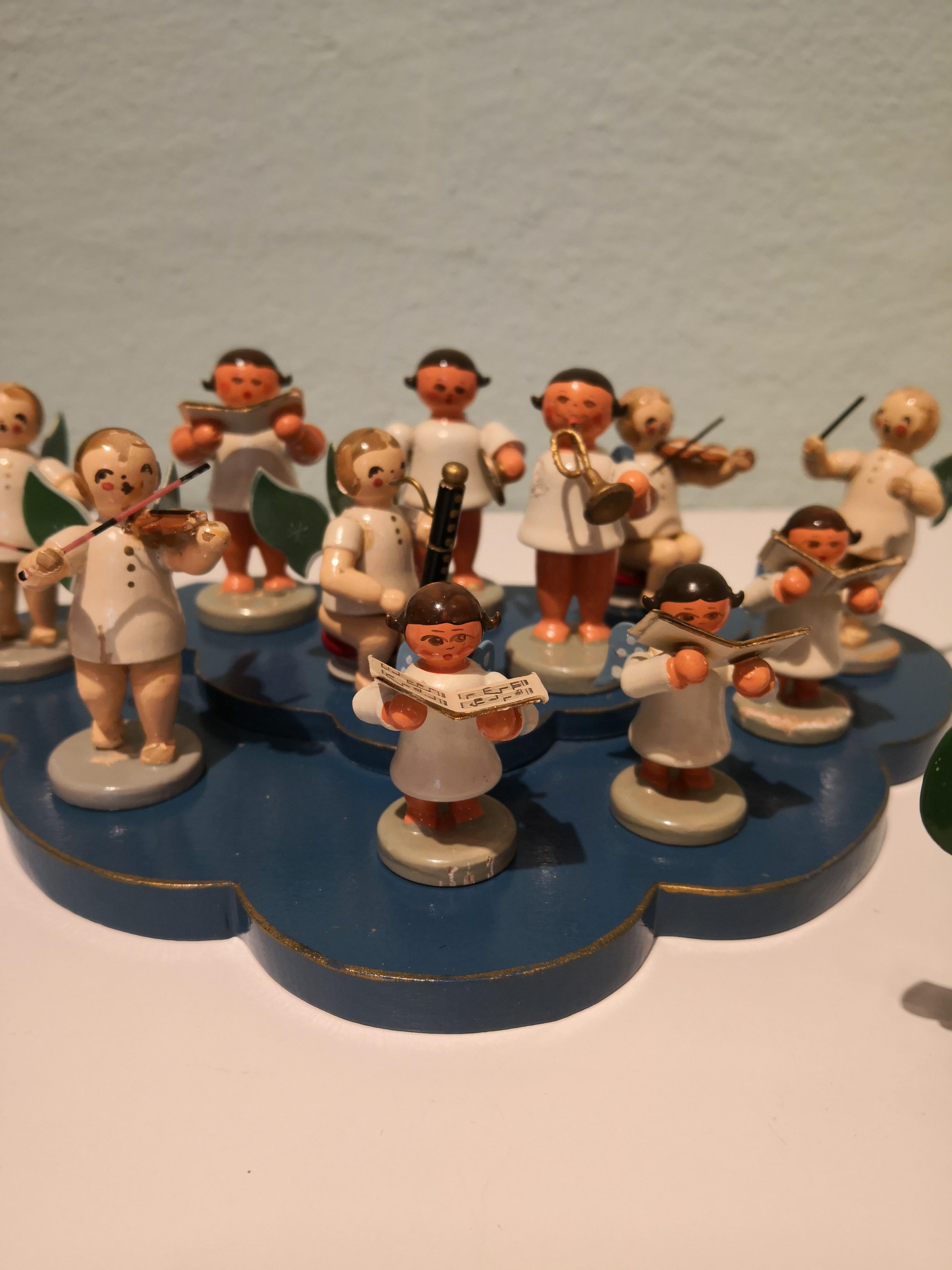 A rare 15 pieces angel concert Christmas decoration from Kühne, Germany. Some angels playing an instrument an the others are singing. All pieces are made of wood and painted by hand. Gorgeous details like notes, painted wings, a separate piano and