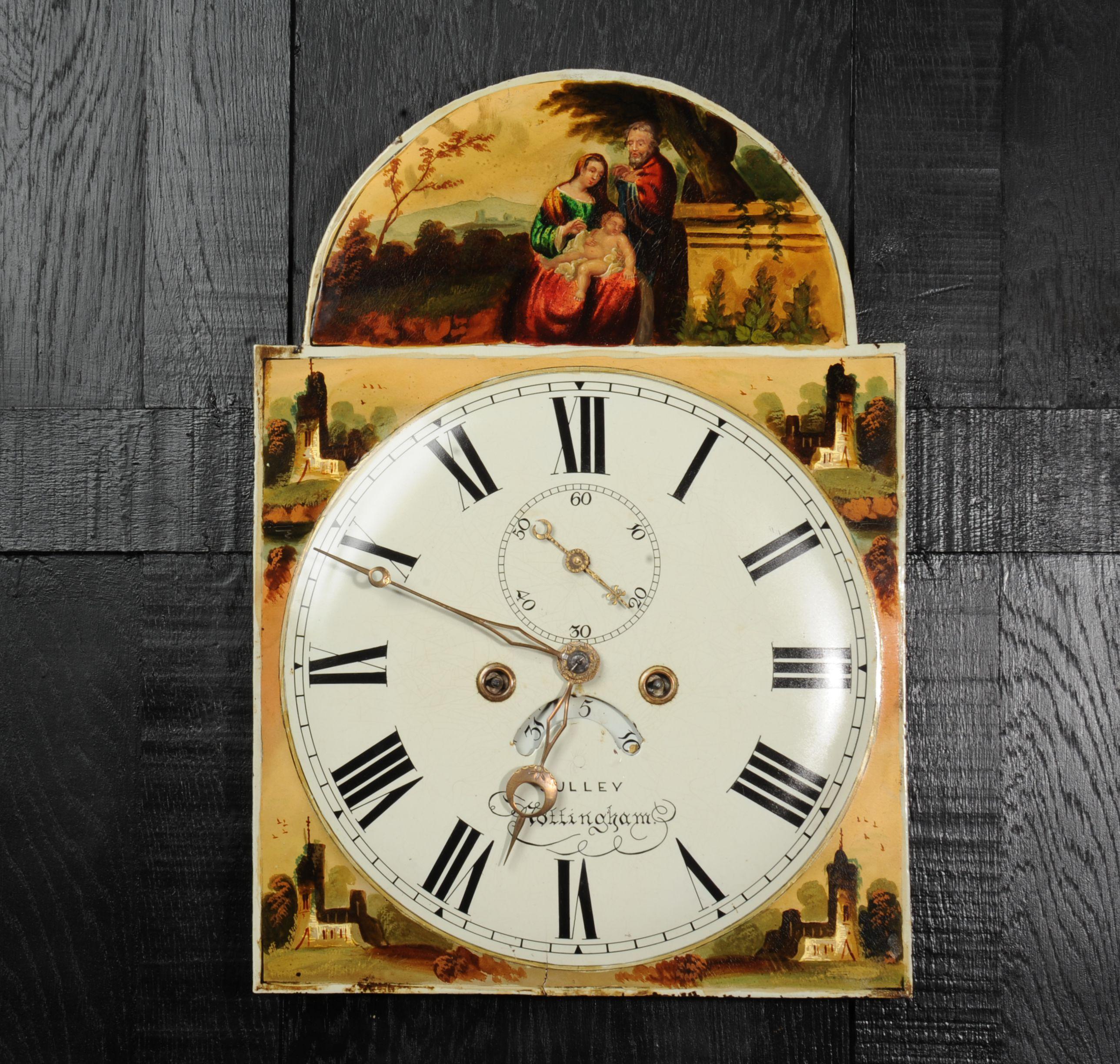 A Rare and lovely antique iron clock dial dating from around 1850. It features a charming painting of the Holy Family, Jesus, Mary and Joseph to the arch. Beautifully painted in the vibrant colours heightened with gold. The spandrels feature
