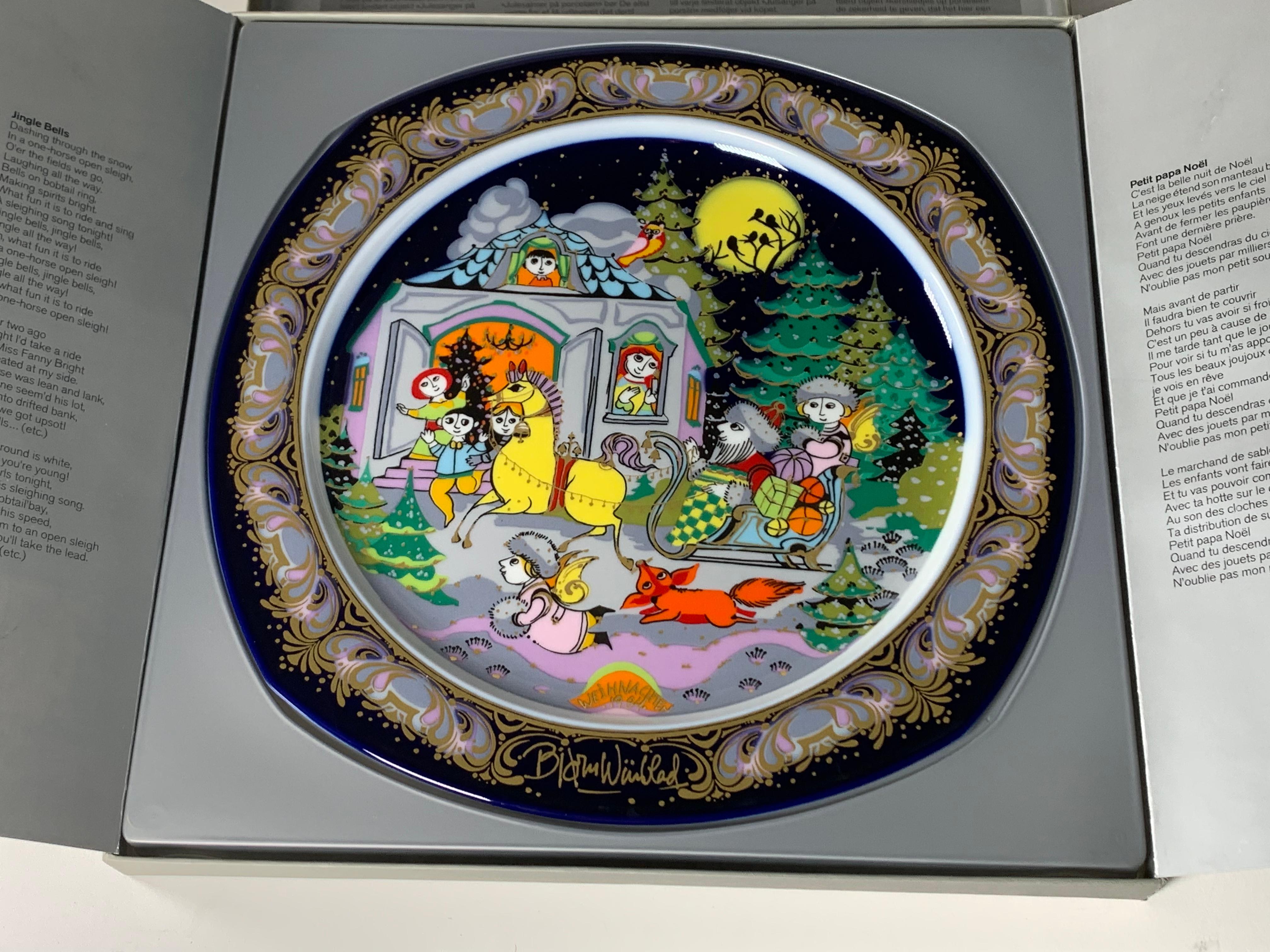 Porcelain Christmas plate from 1984 by Bjorn Wiinblad made by the German manufacturer Rosenthal. The dish is titled “Jingle Bells” and is reason no. 2 of the series. When Rosenthal asked the Danish artist to illustrate a new series of dishes, he