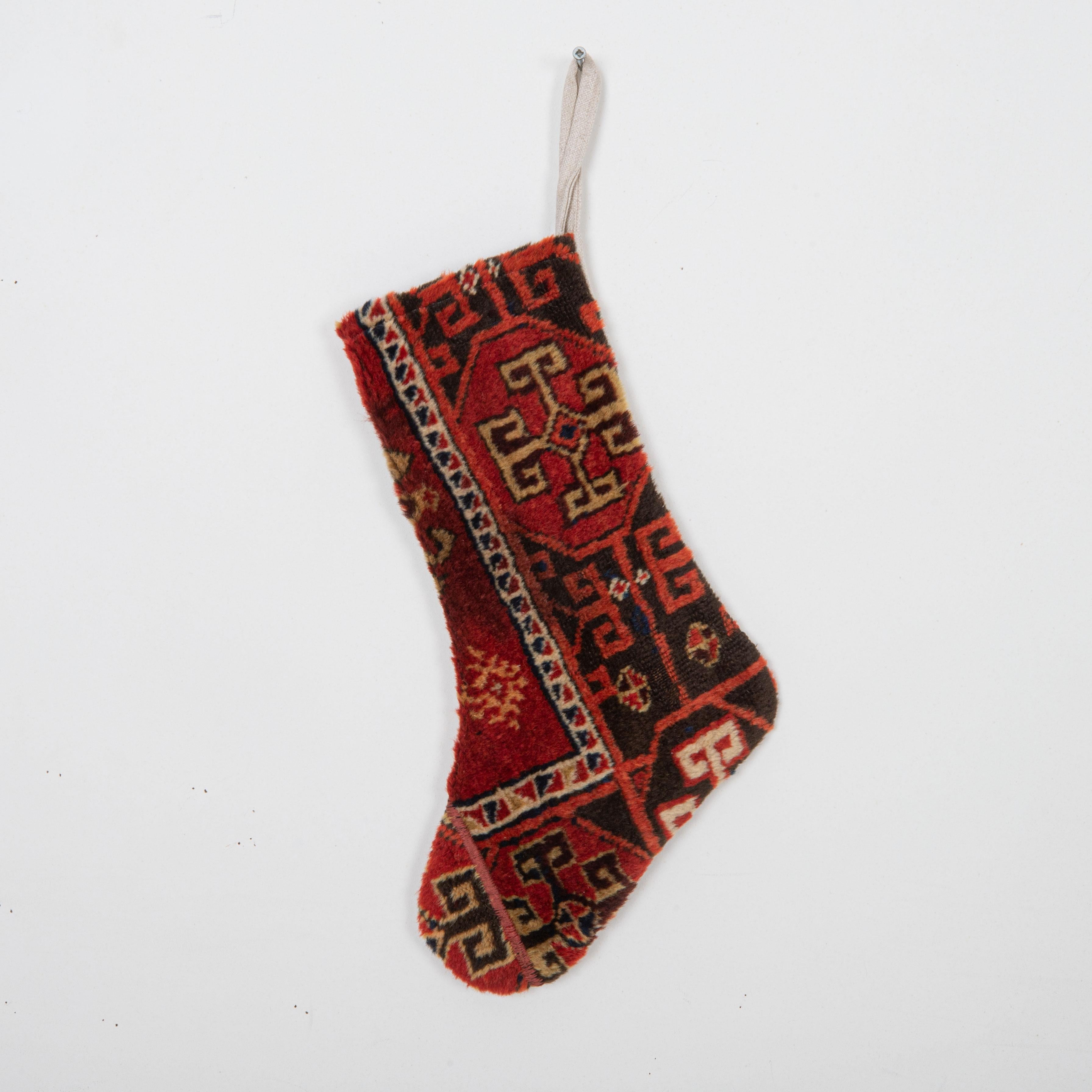 This Christmas Stocking was made from a late 19th or Early 20th C. Anatolian rug fragments.
Linen in the back.

Please note, this stocking was made from Anatolian rug fragments.
