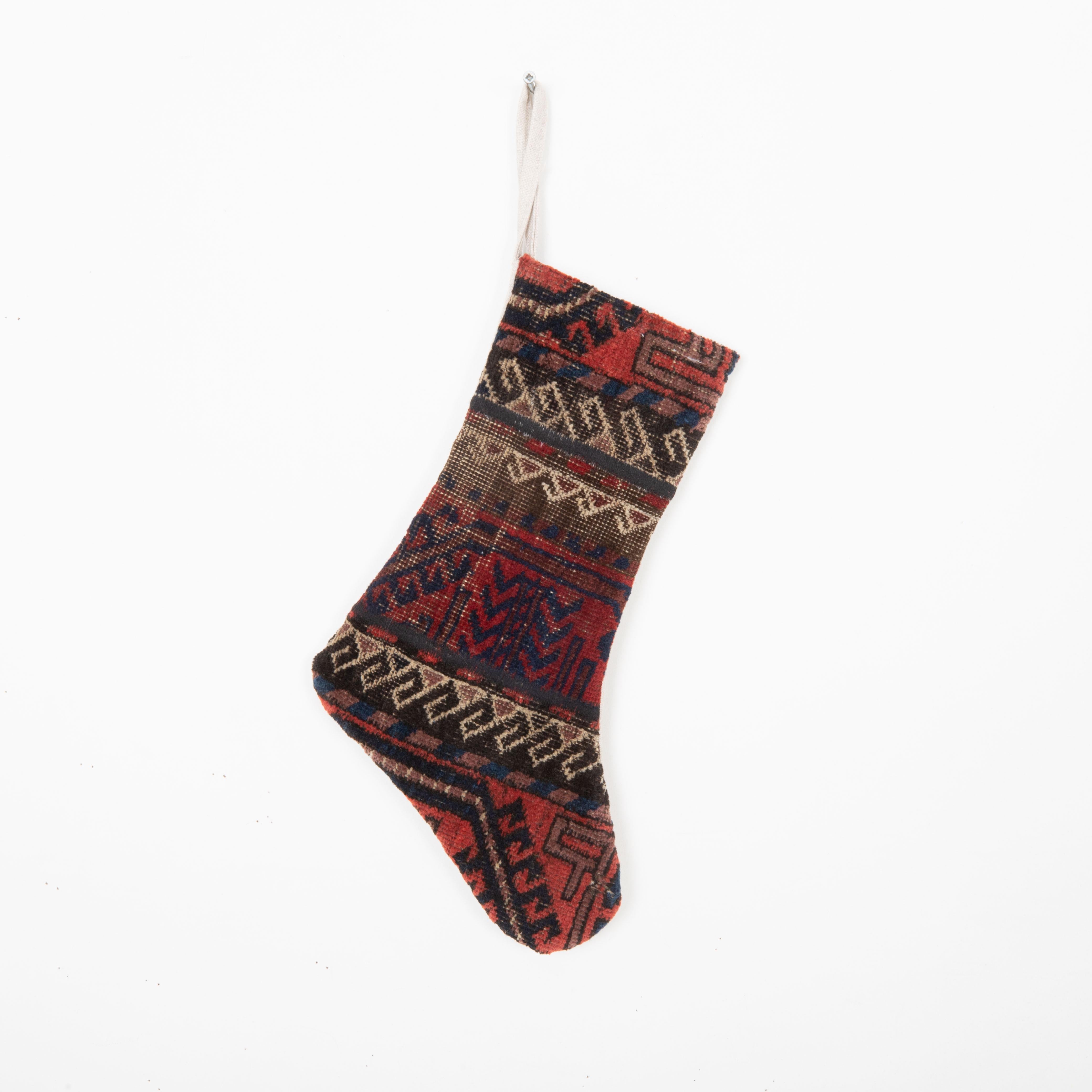 This Christmas Stocking was made from a late 19th or Early 20th C. Baluch rug fragments.
Linen in the back.

Please note, this stocking was made from Baluch rug fragments.
