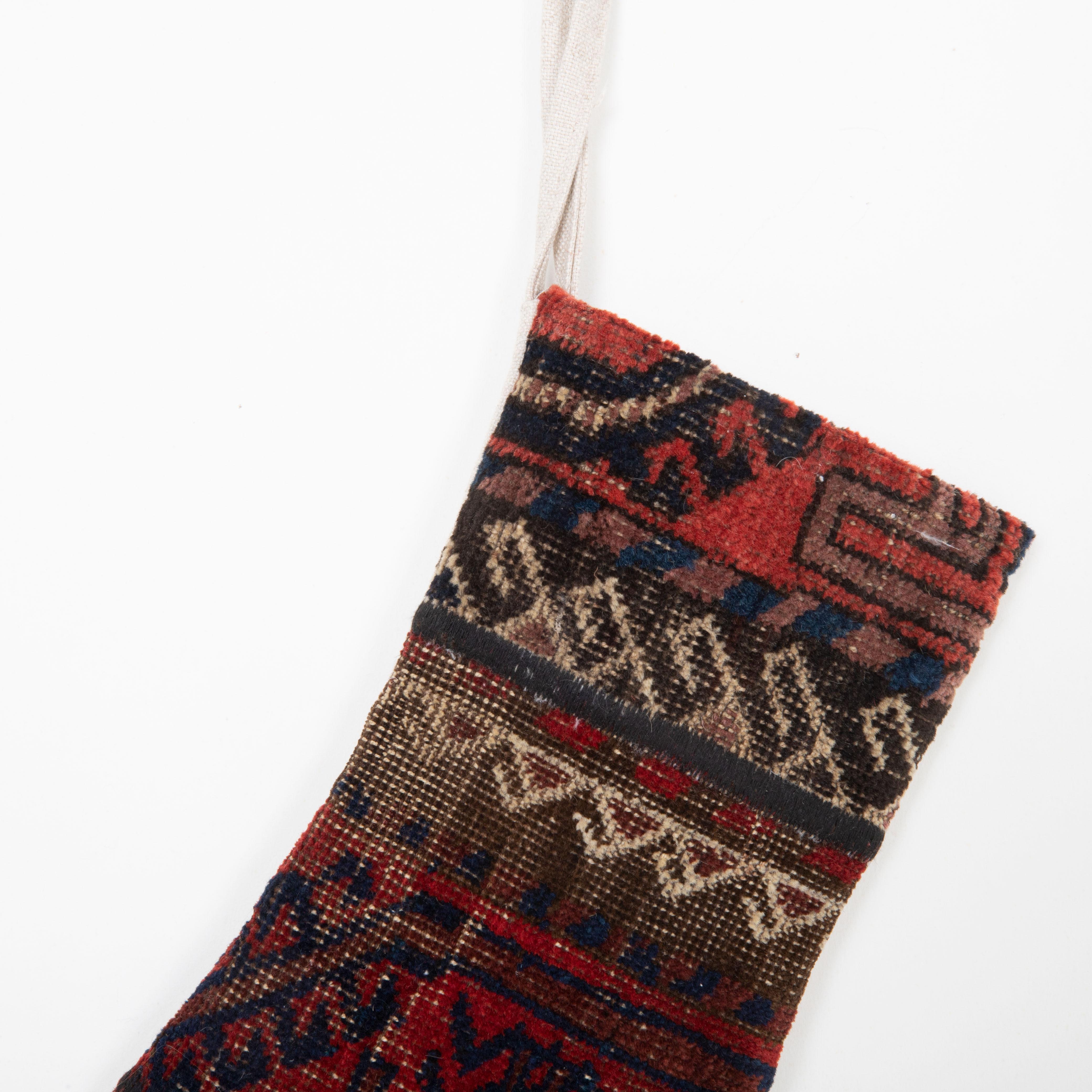 Hand-Knotted Christmas Stocking Made from Baluch Rug Fragments For Sale