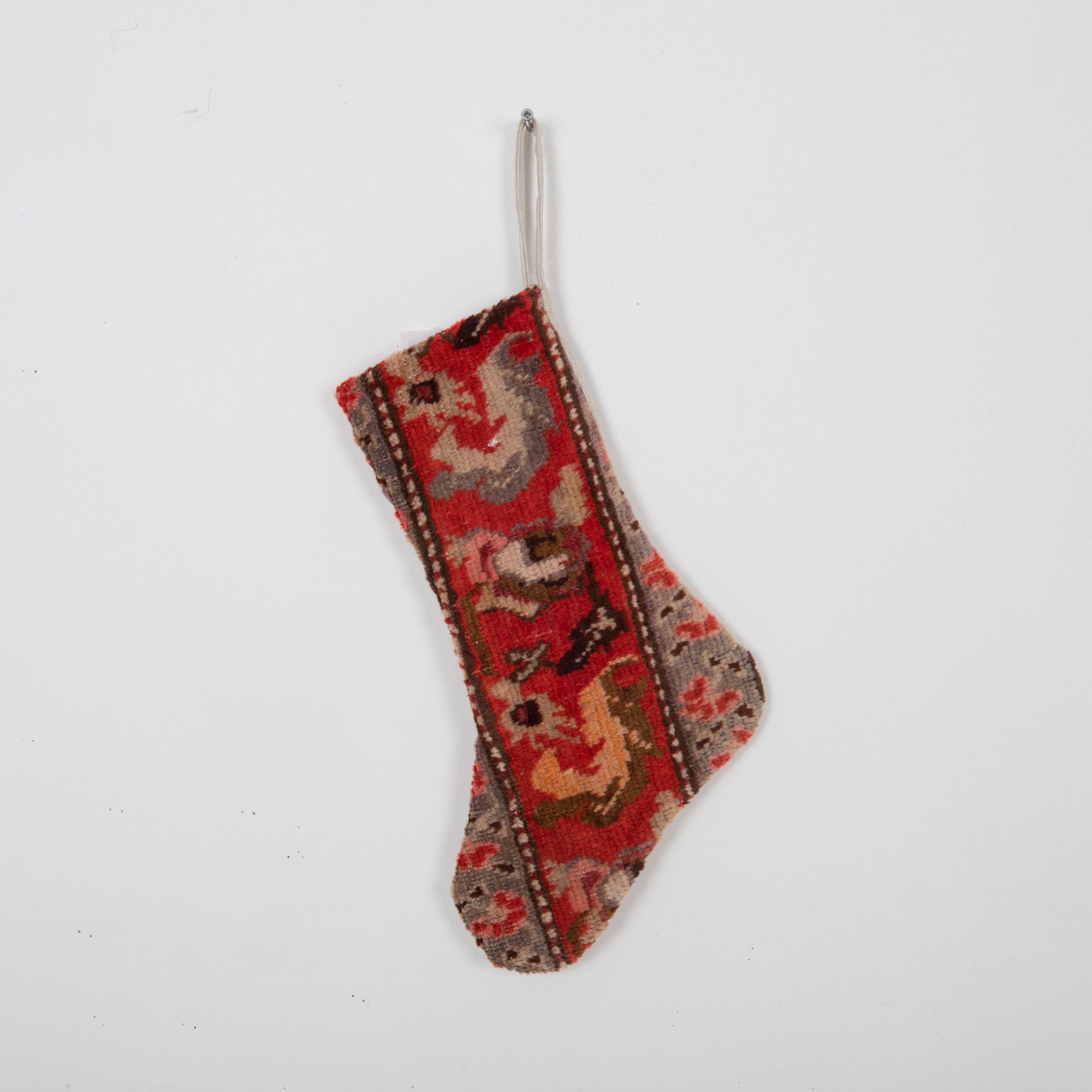 This Christmas Stocking was made from a late 19th or Early 20th C. Caucasıan rug fragments.

Linen in the back.

Please note, this stocking was made from  caucasian rug fragments.