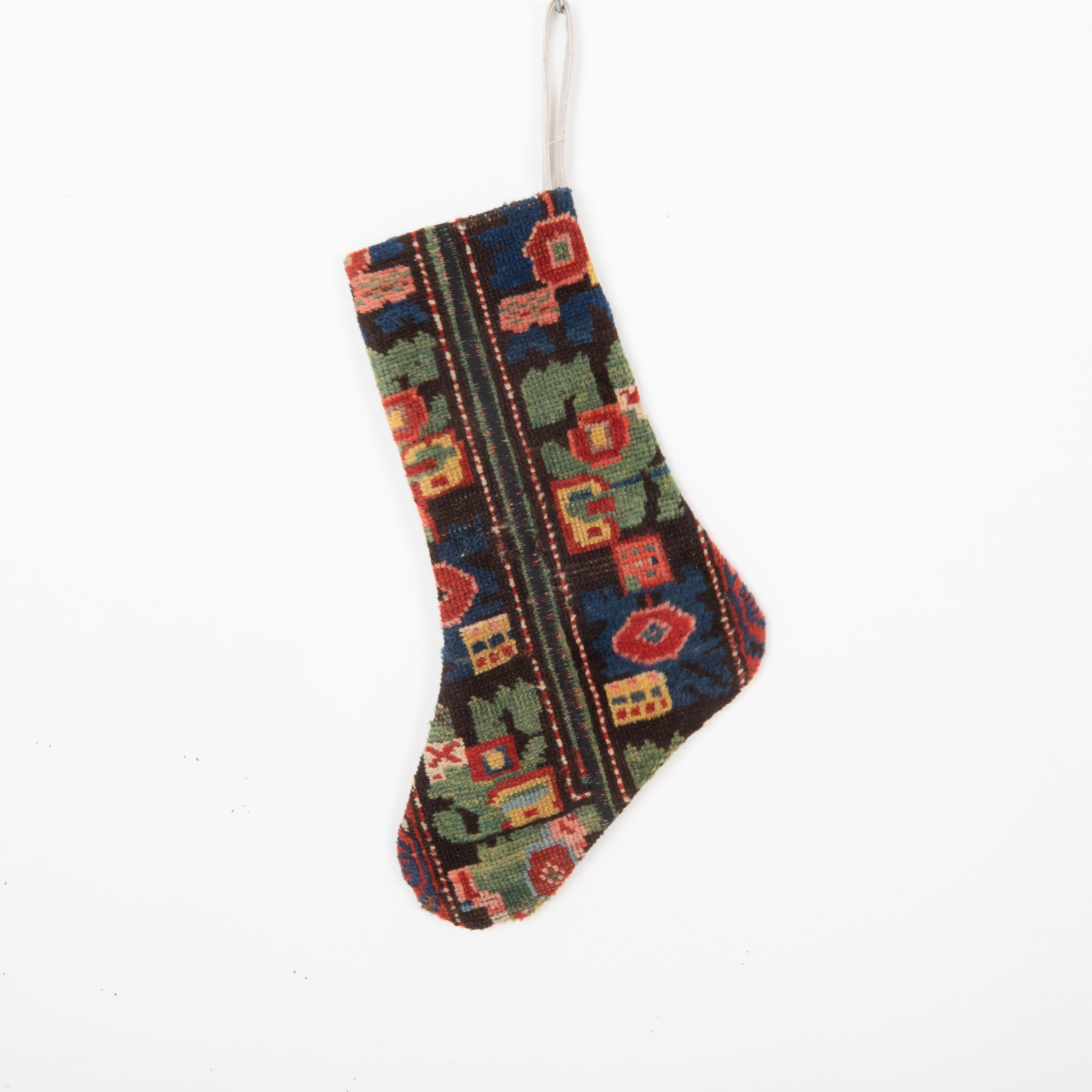 This Christmas Stocking was made from a late 19th or Early 20th C. Caucasıan rug fragments.
Linen in the back.
