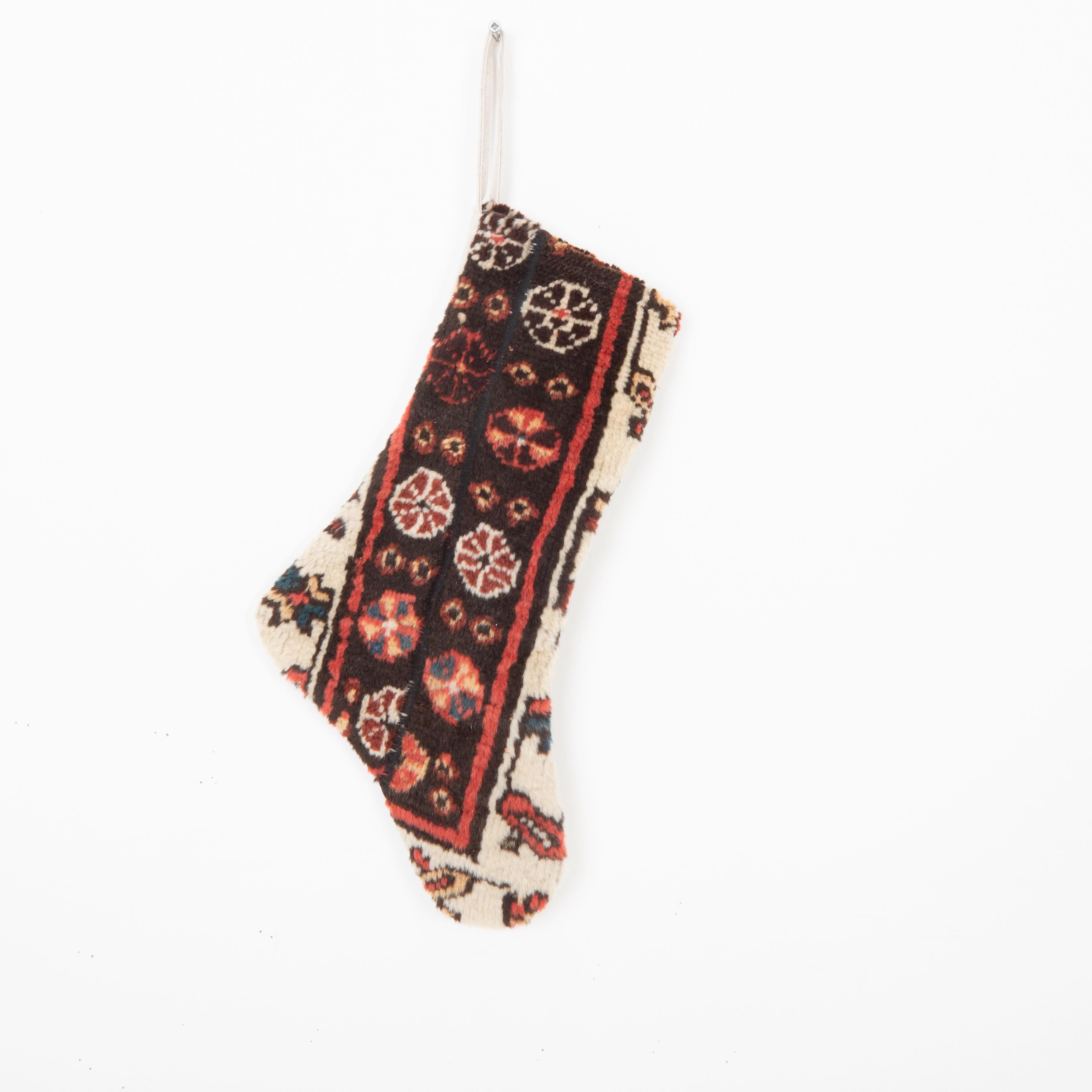 This Christmas Stocking was made from a late 19th or Early 20th C. Caucasıan rug fragments.
Linen in the back.

Please note, this stocking was made from caucasian 
