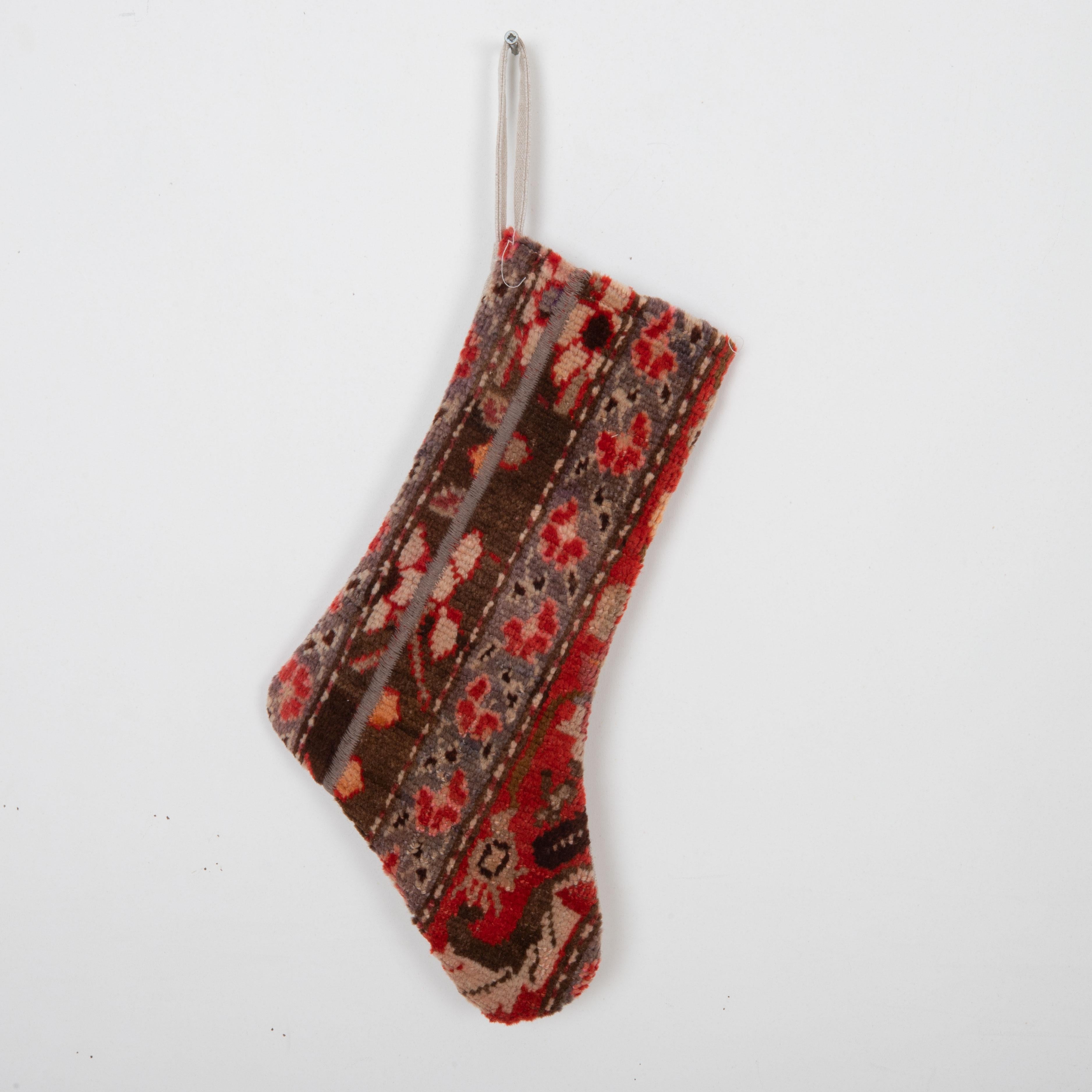 This Christmas Stocking was made from a late 19th or Early 20th C. Caucasian rug fragments.
Linen in the back.

Please note, this stocking was made from caucasian rug fragments.
